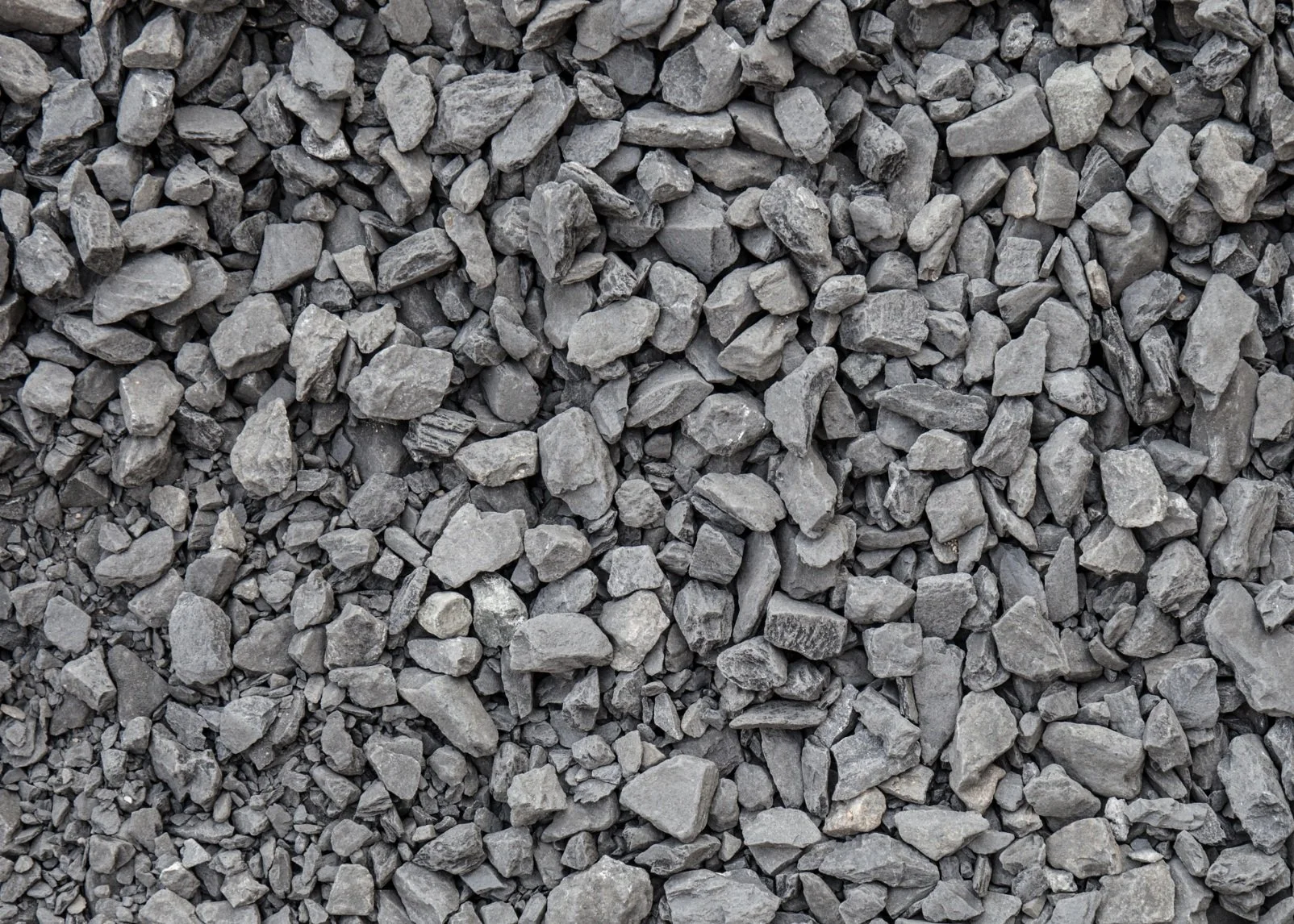 A close-up view of gray gravel stones of various sizes and shapes