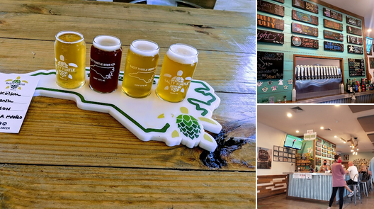 Four small glasses of beer, with two dark and two light, are arranged on a wooden table on a beer flight paddle shaped like a map of Pennsylvania.