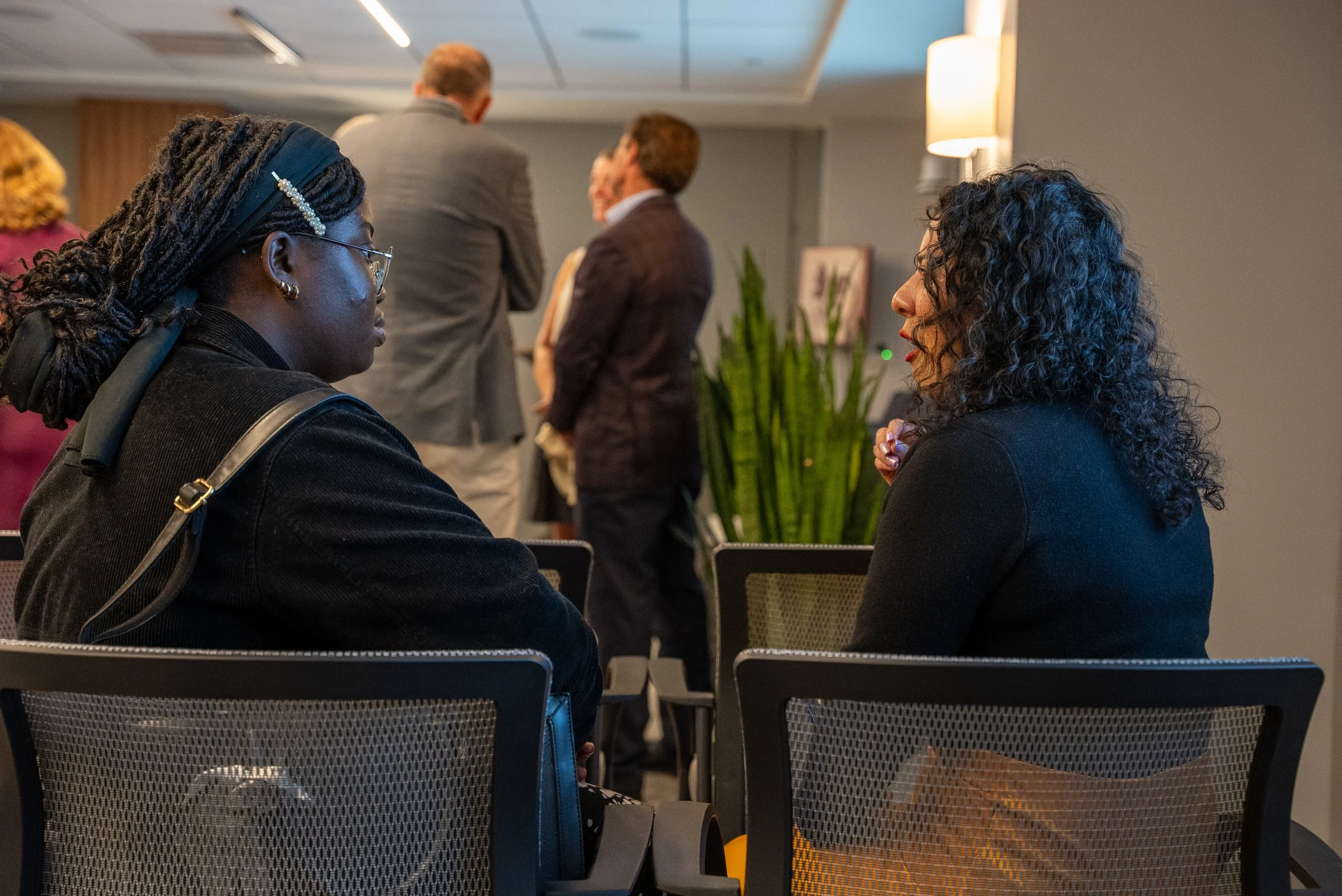 Women conversing at a foundation event.