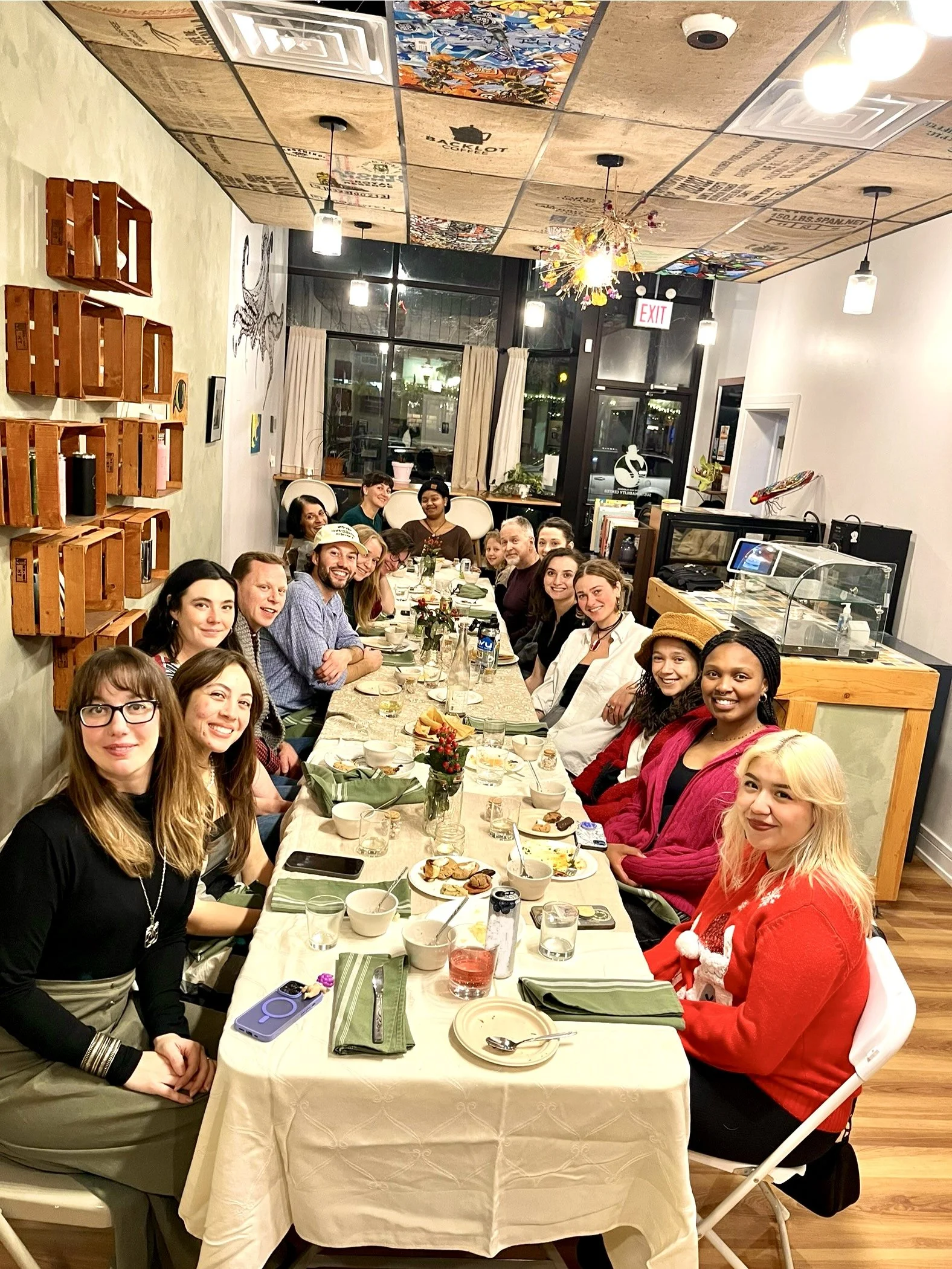 Group of people gathered around a long dining table.