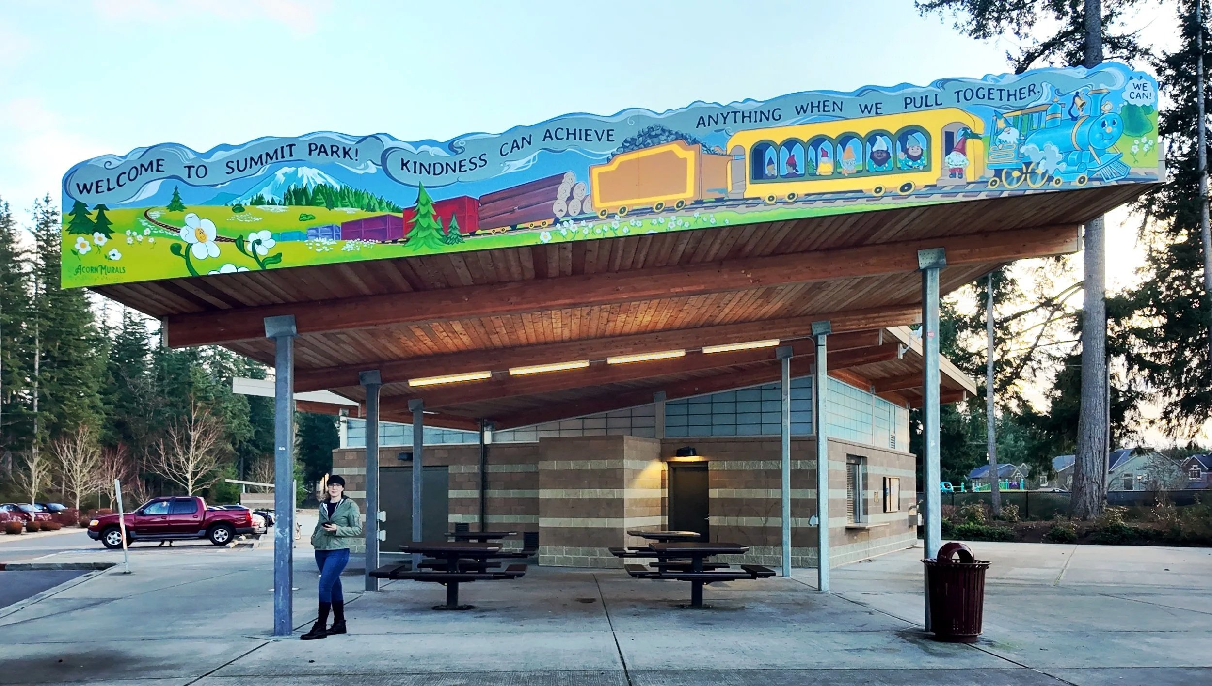 Mural by artist Shelly Metzger of Acorn Murals, installed at Summit Park in Maple Valley. The mural is a whimsical depiction of Maple Valley's history of coal, timber, and passenger rail. 