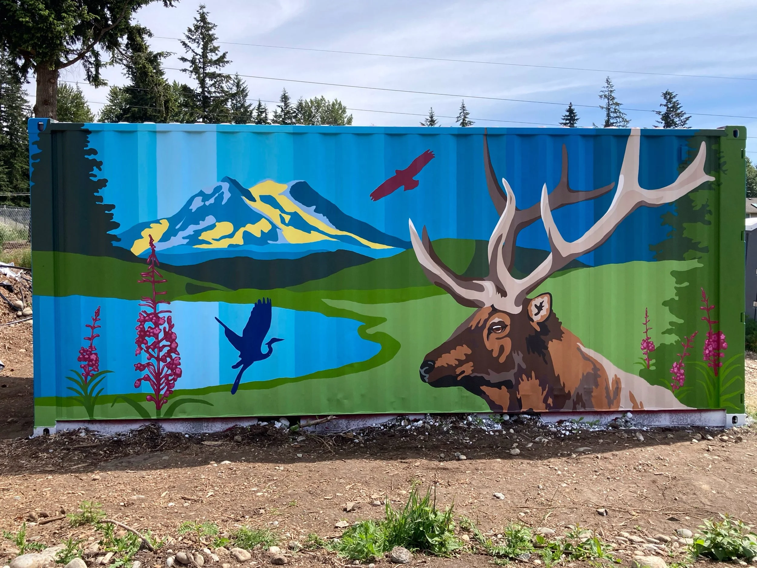 Mural painted on Elk Run Farm's shipping container highlighting an elk, Mount Tahoma, Mount Rainier, a great blue heron, and a red tailed hawk, fireweed, and evergreen trees. Acorn Murals, Shelly Metzger, Maple Valley. Best murals in Maple Valley, be