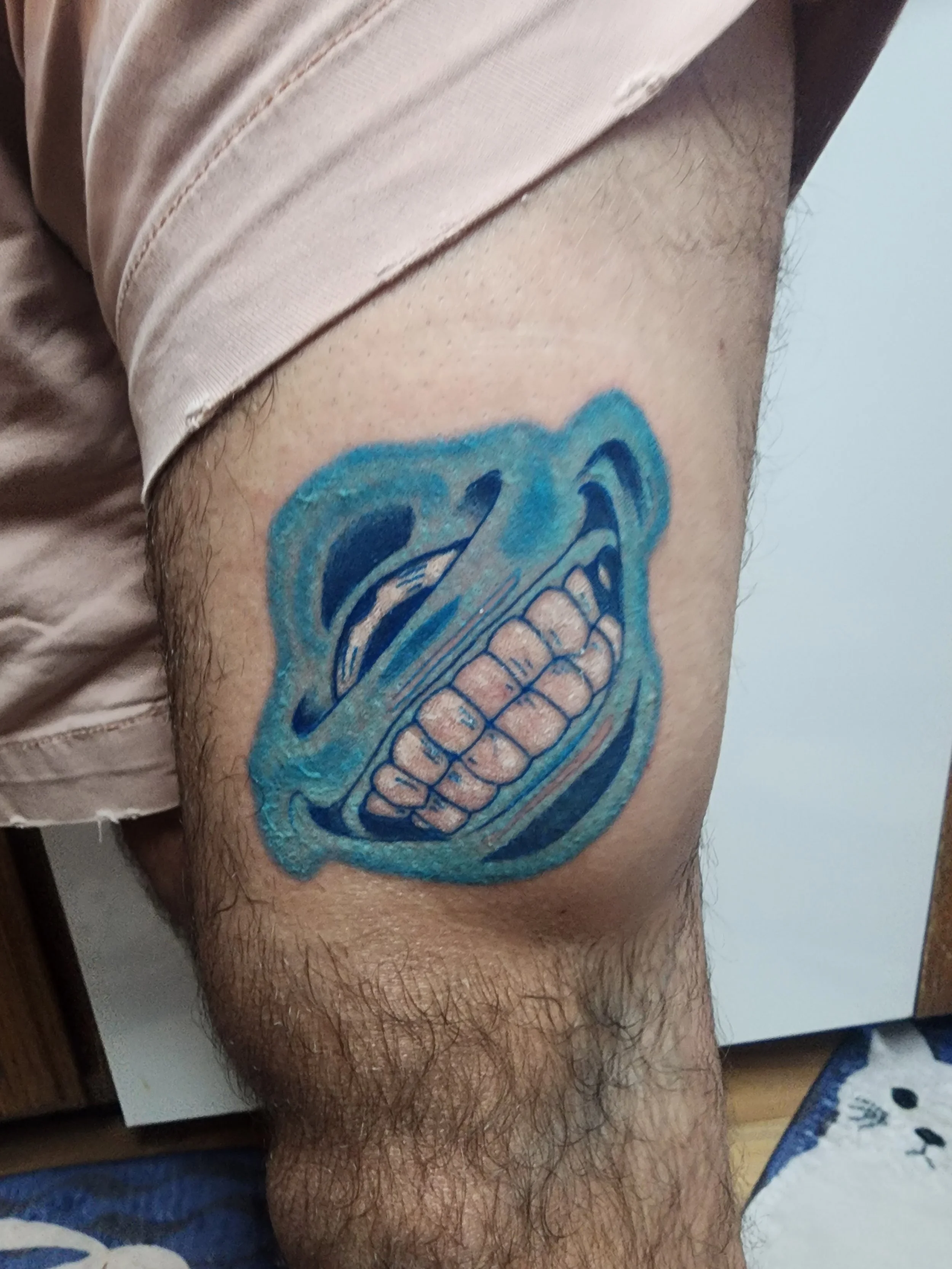 Jujutsu Kaisen anime tattoo of Jogo looking up and smiling, done by the best tattoo artist in Redding at Caddy Daddy's