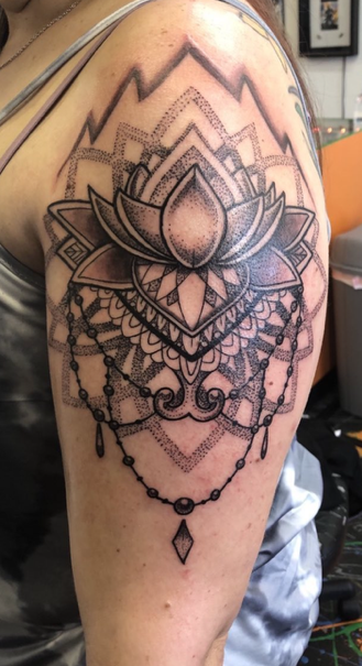 mandala style flower tattoo on shoulder
