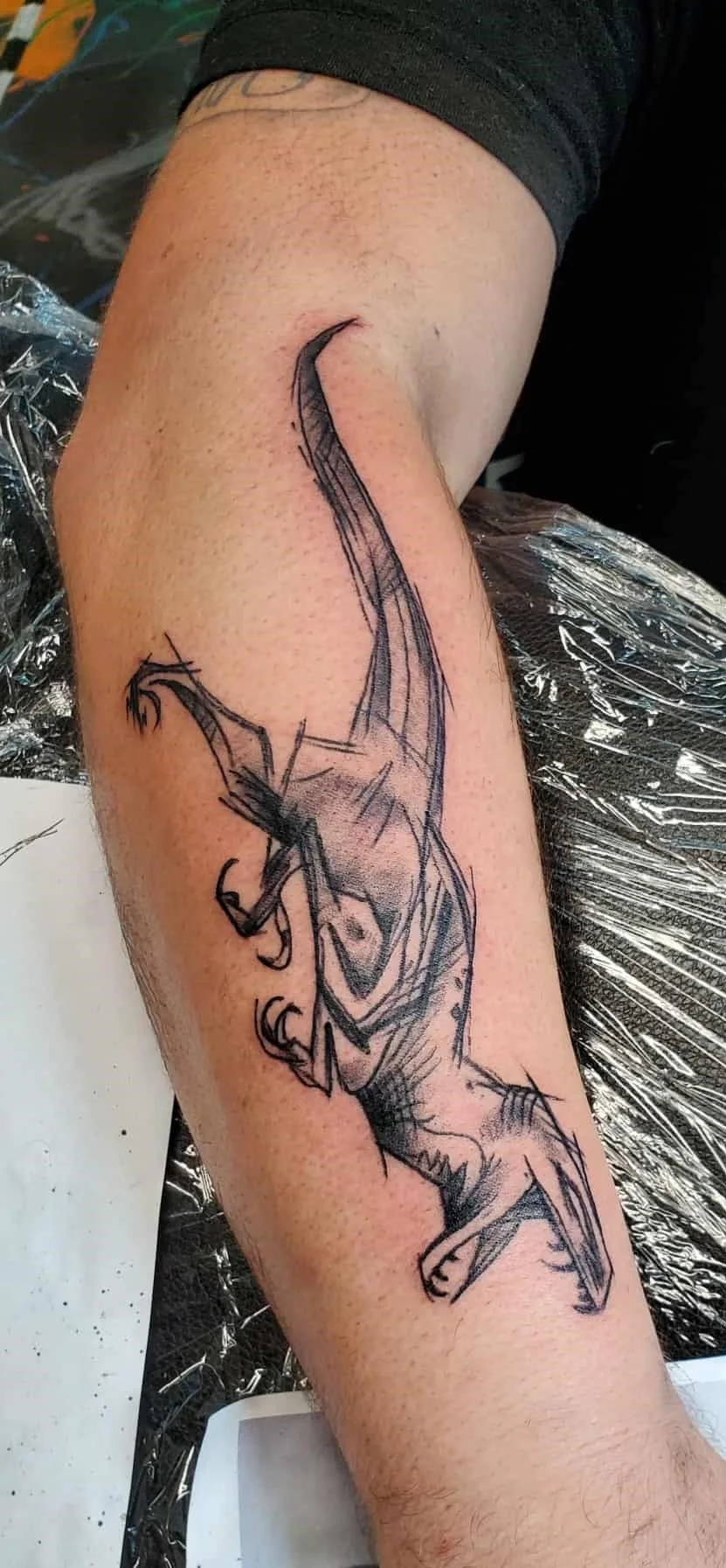 Velociraptor tattoo on the forearm done by a Redding tattoo artist
