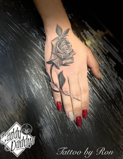 rose tattoo on hand