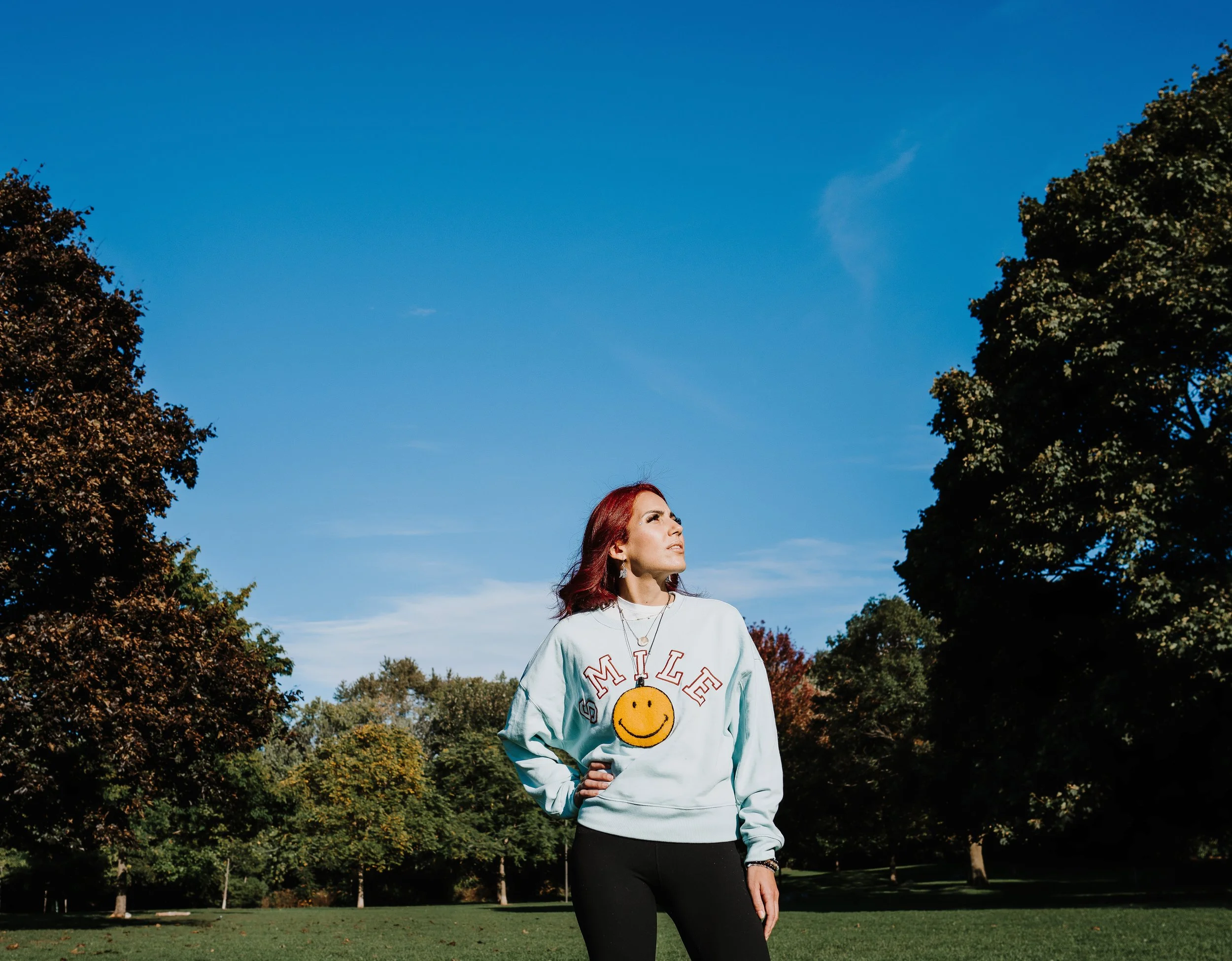 owner taking a moment outdoor outdoors in a park with trees and a blue sky in Toronto park