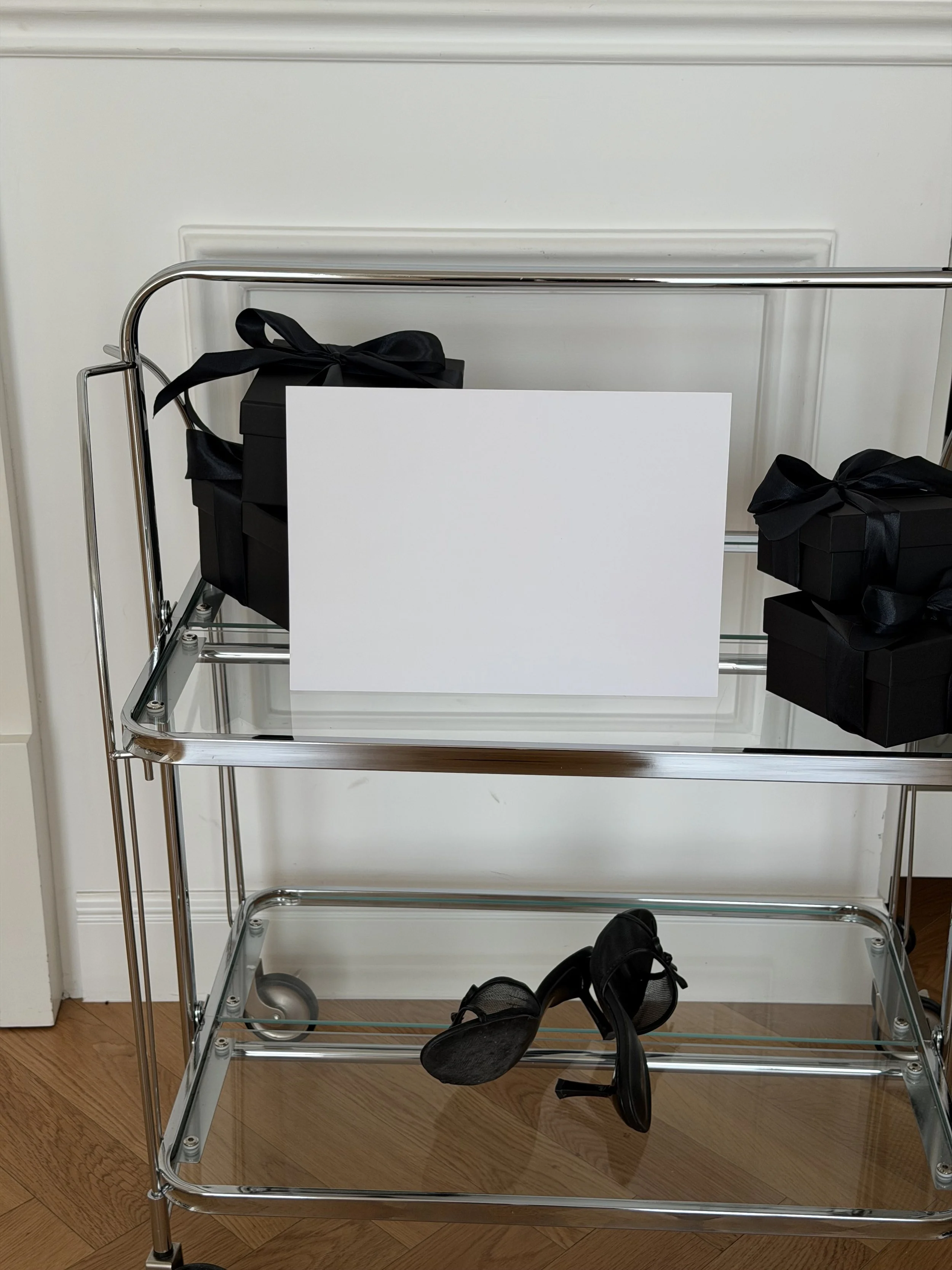 Blank sign mockup on a bar cart with black gifts and heels, ready for your Black Friday offer