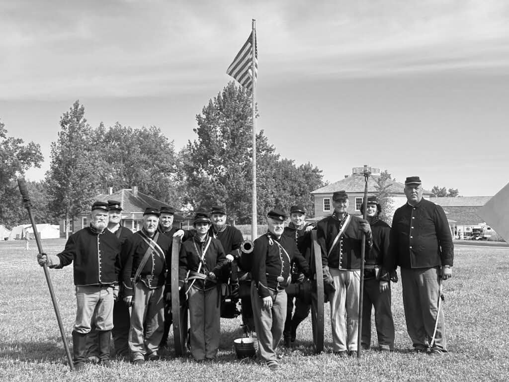 Civil War Reinatctors posing in front of USA flag