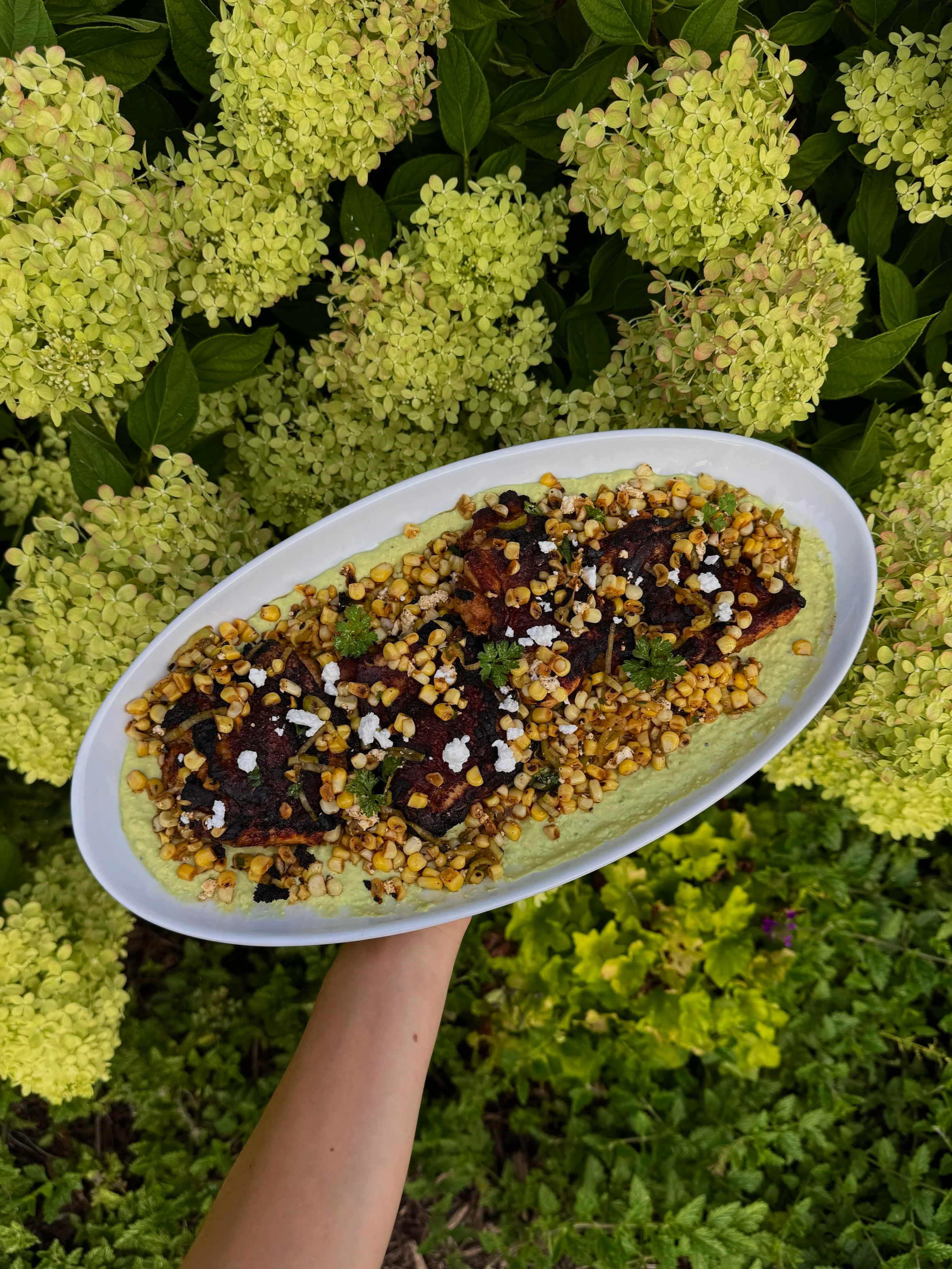 Roasted Peruvian Chicken Thighs w/ Grilled Feta Corn Salad