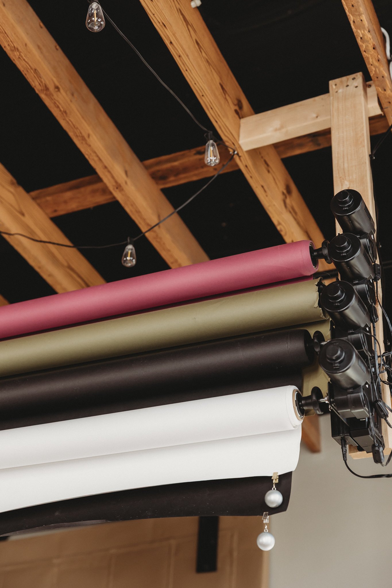 Colorful studio backdrop rolls mounted on a wall