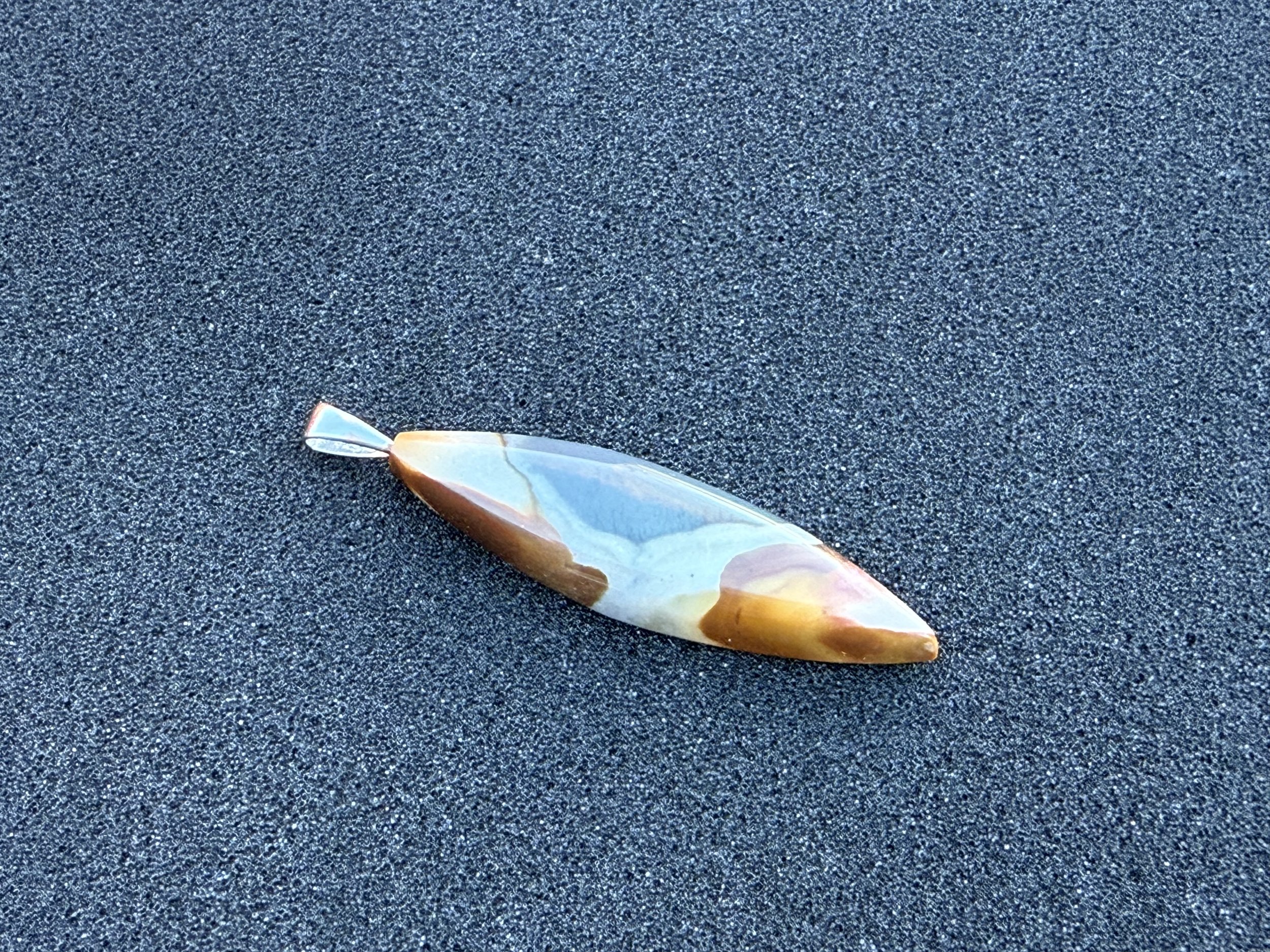 Handcrafted natural Polychrome Jasper pendant under indirect sunlight.