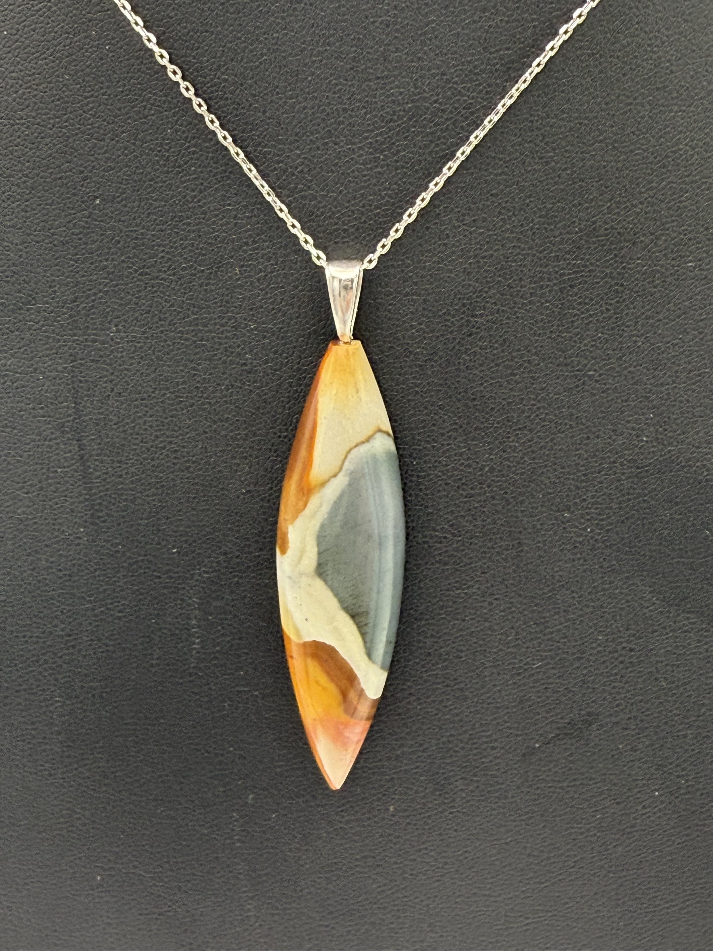 Artist created one of a kind polychrome Jasper pendant close-up.