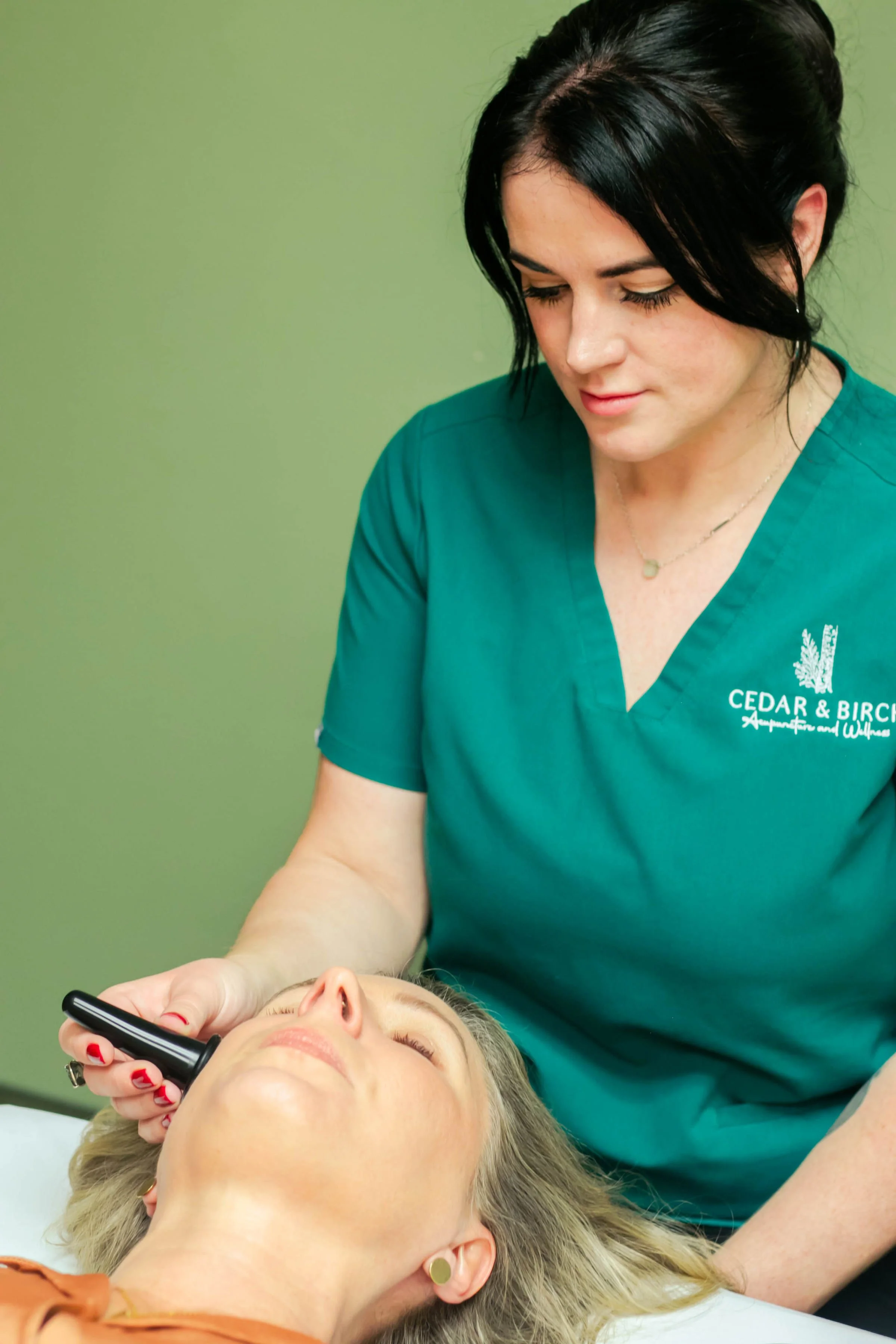A healthcare professional uses a device on a patient's face during a facial treatment. Kirkland, Washington. Vancouver, Washington. Mental health. Women's health. Fertility. Menopause. Microneedling. Cosmetic acupuncture.