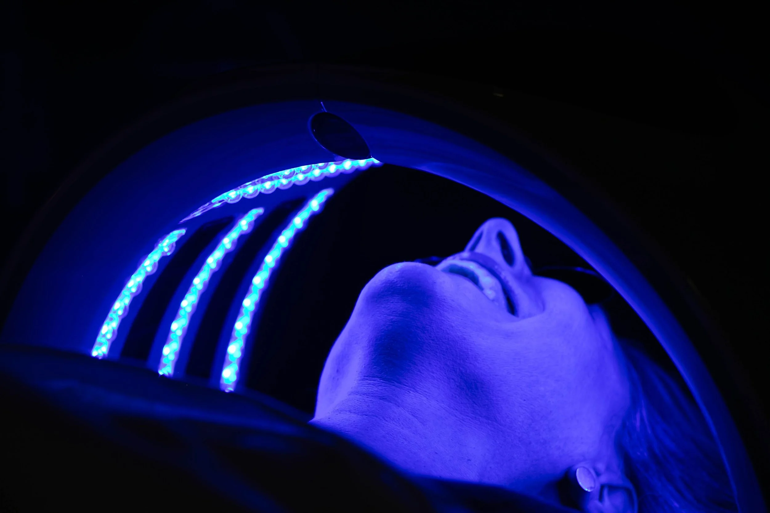 Person undergoing red light therapy for facial rejuvenation by a practitioner. Kirkland, Washington. Vancouver, Washington. Mental health. Women's health. Fertility. Menopause. Microneedling. Cosmetic acupuncture.