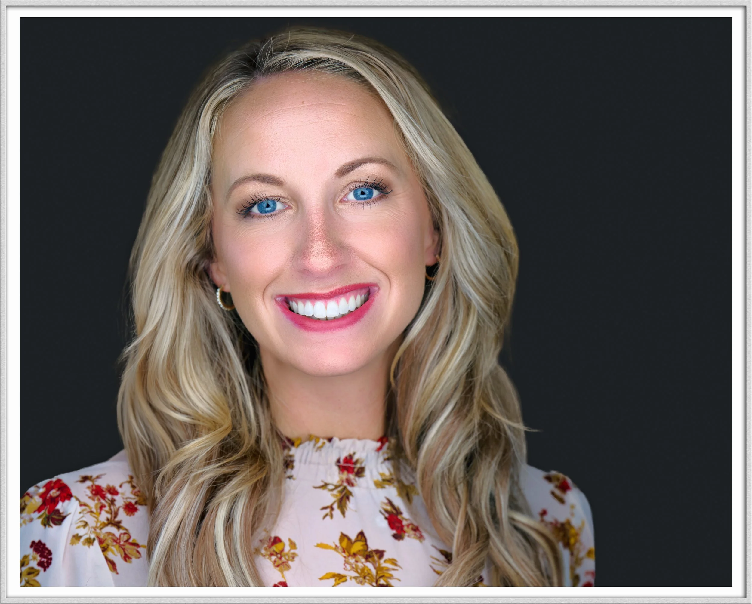 Framed professional headshot of a woman photographed with soft, polished studio lighting, showcasing executive portrait photography in a refined, gallery-inspired style.