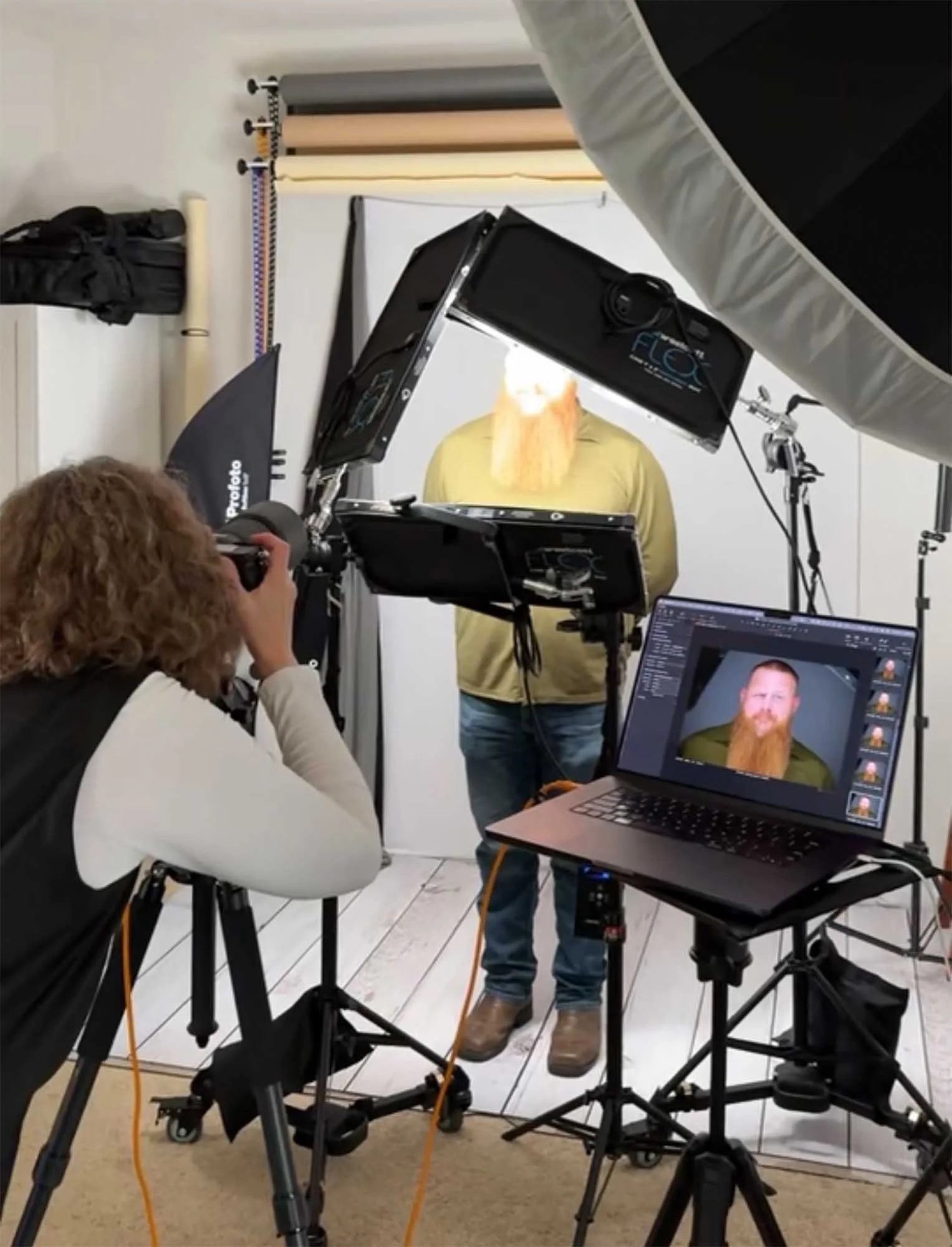 Professional headshot photographer in Cincinnati taking picture of client.