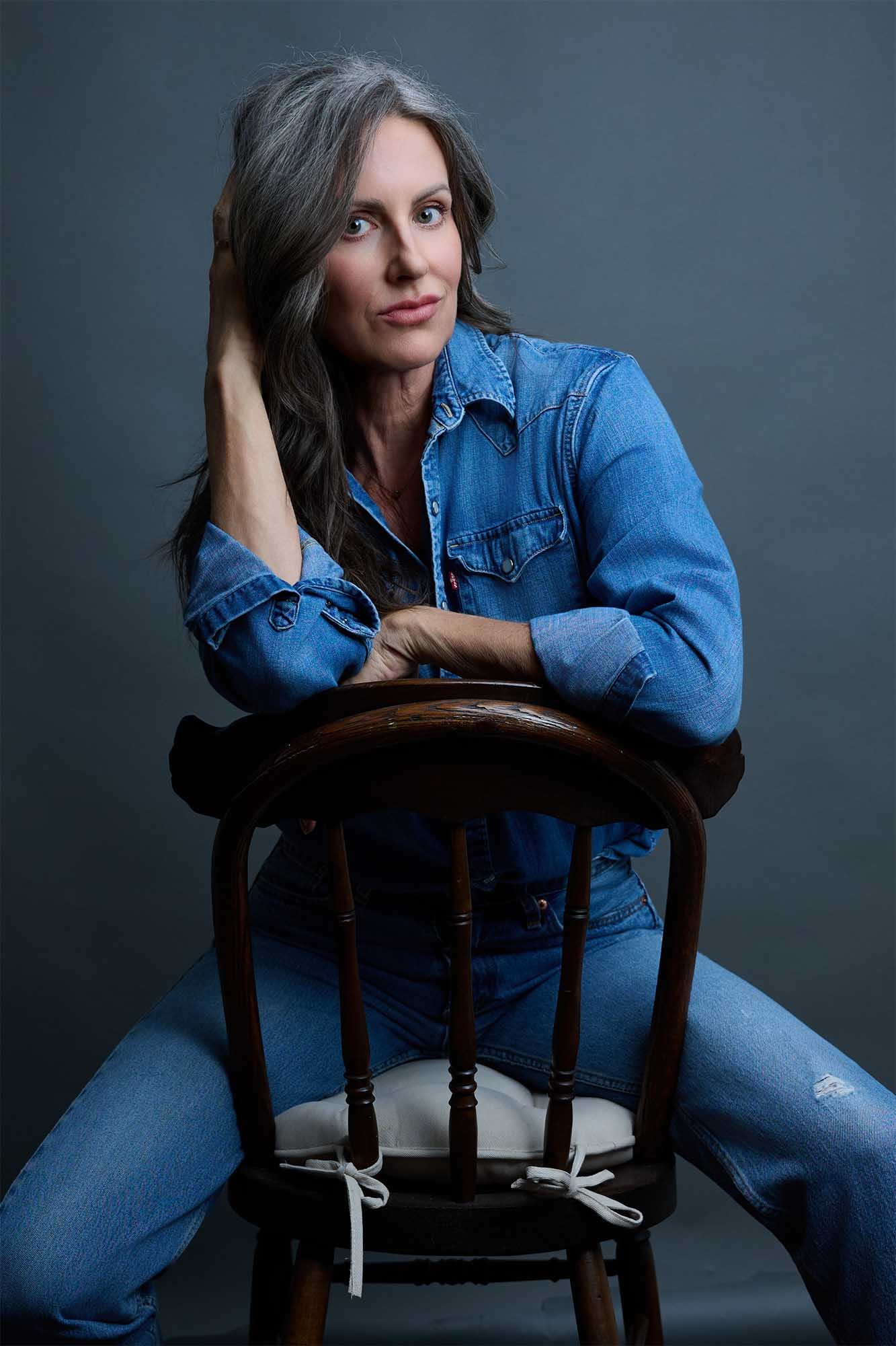 Professional model wearing blue jeans and blue shirt in portrait session