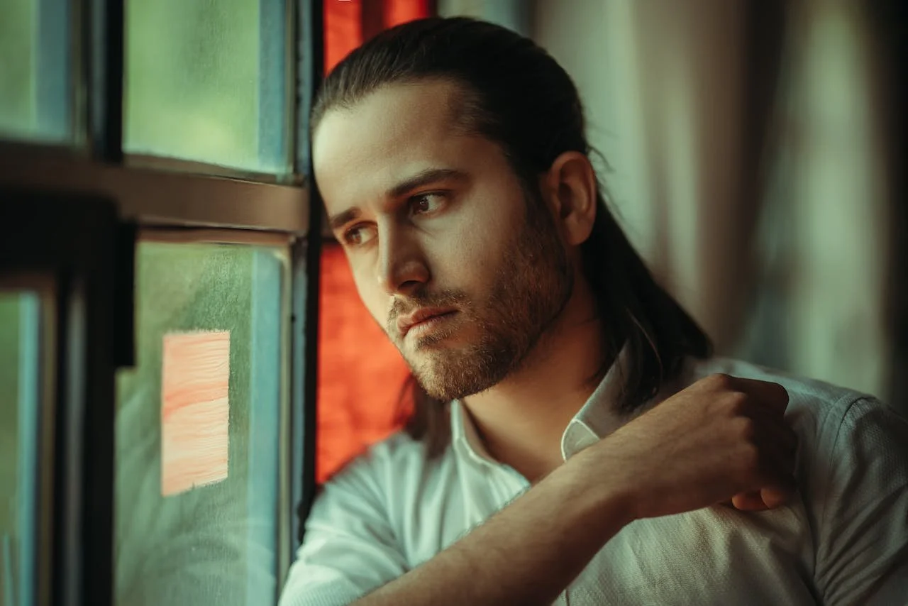 man-in-shirt-by-window