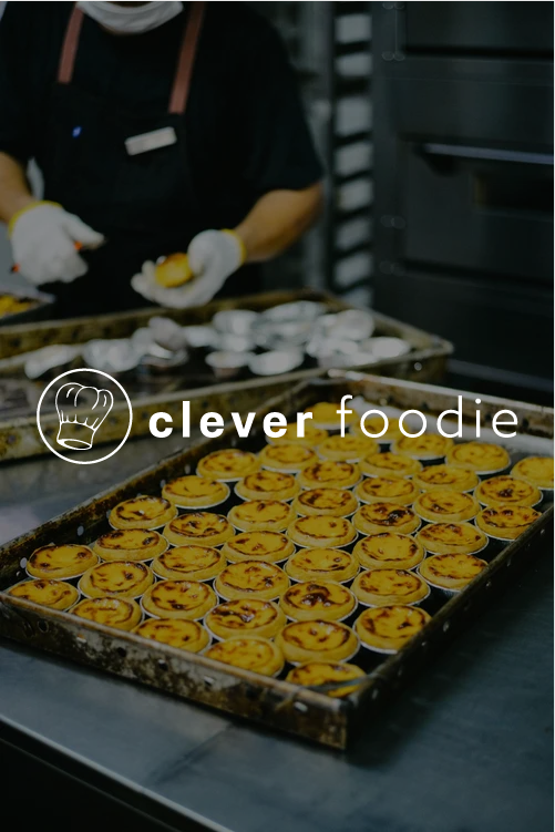 Tray of baked egg tarts in a commercial kitchen.