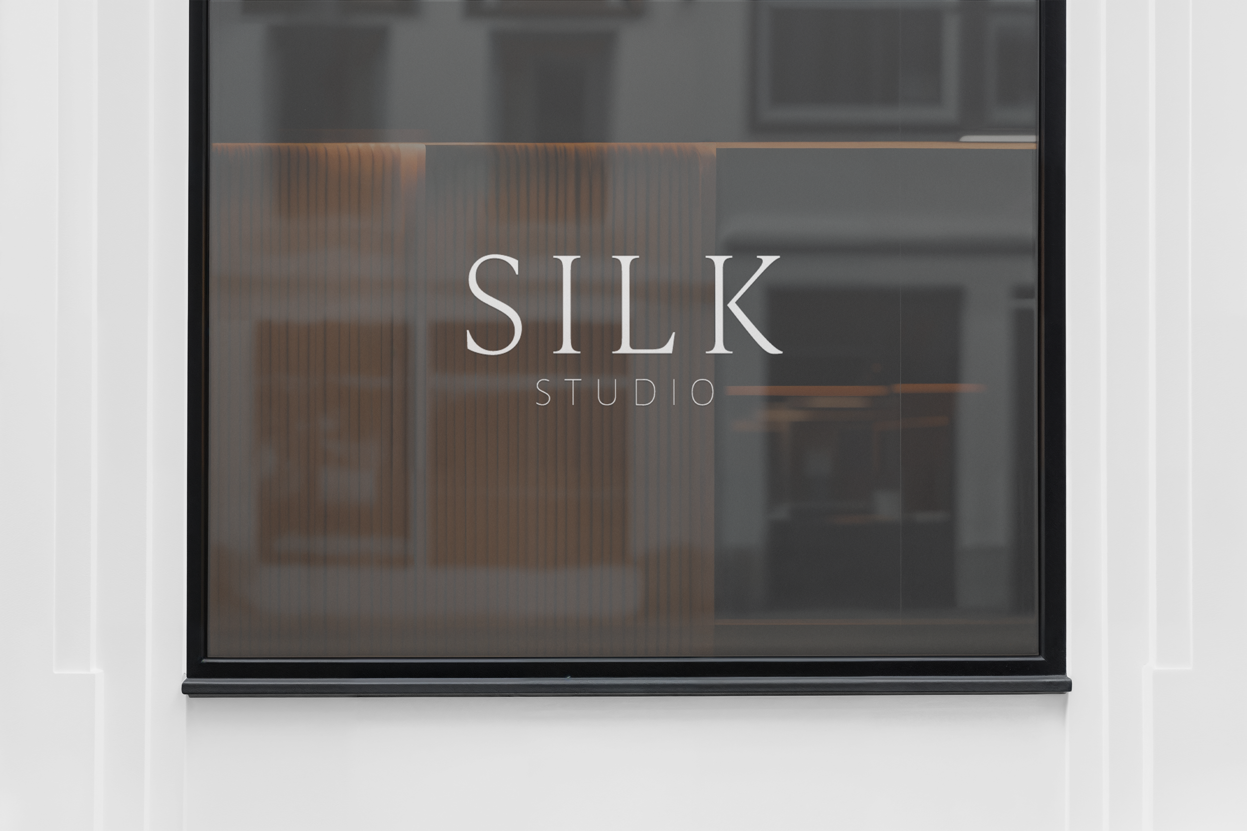 Glass door with the words 'SILK STUDIO' written on it.