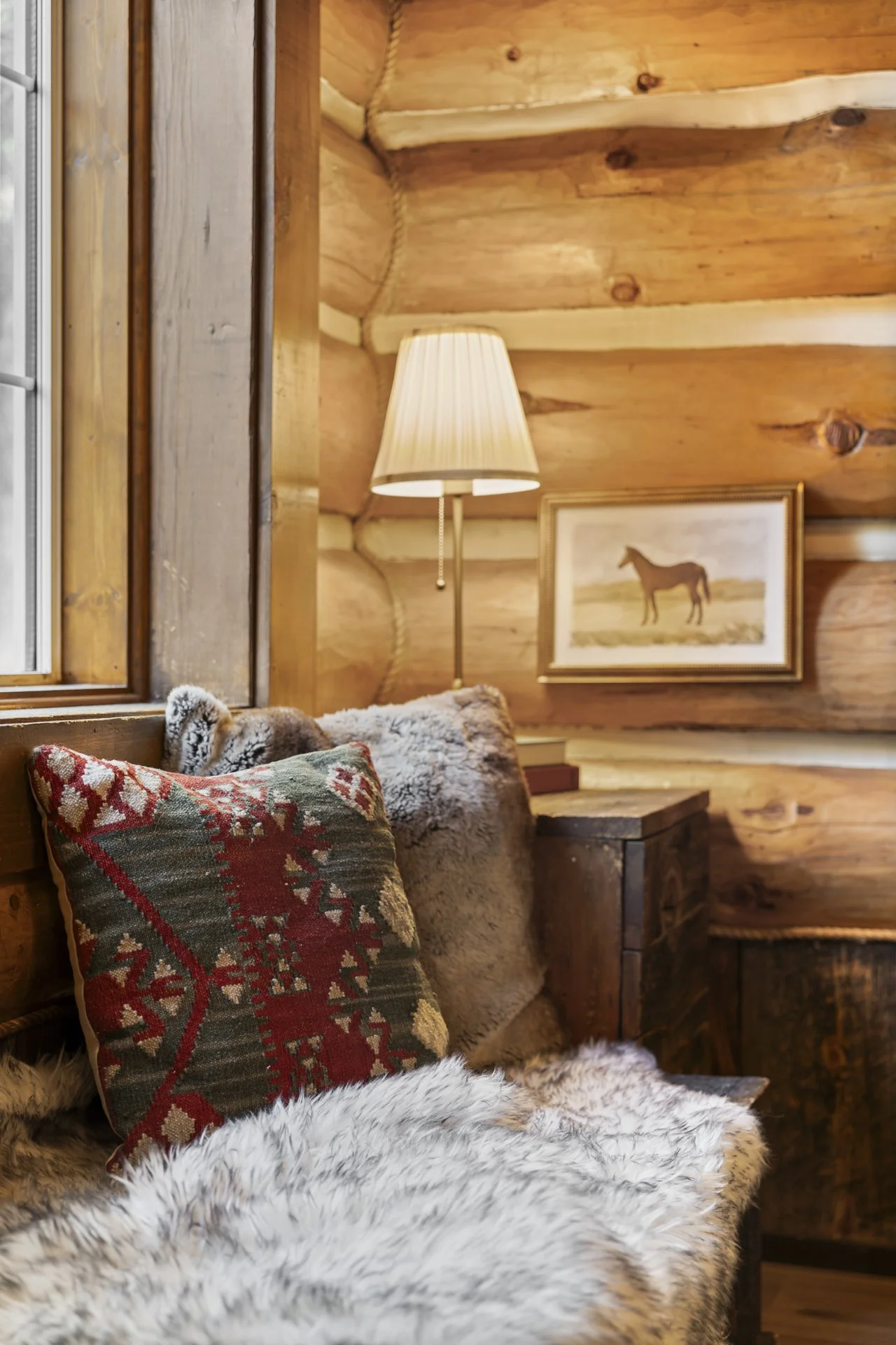 Great room with exposed log walls and vaulted ceilings
