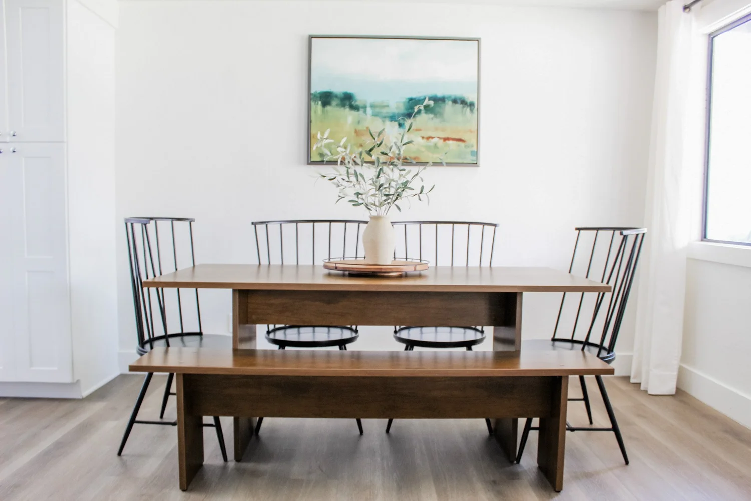 Dining area with organic-shaped lighting and natural wood