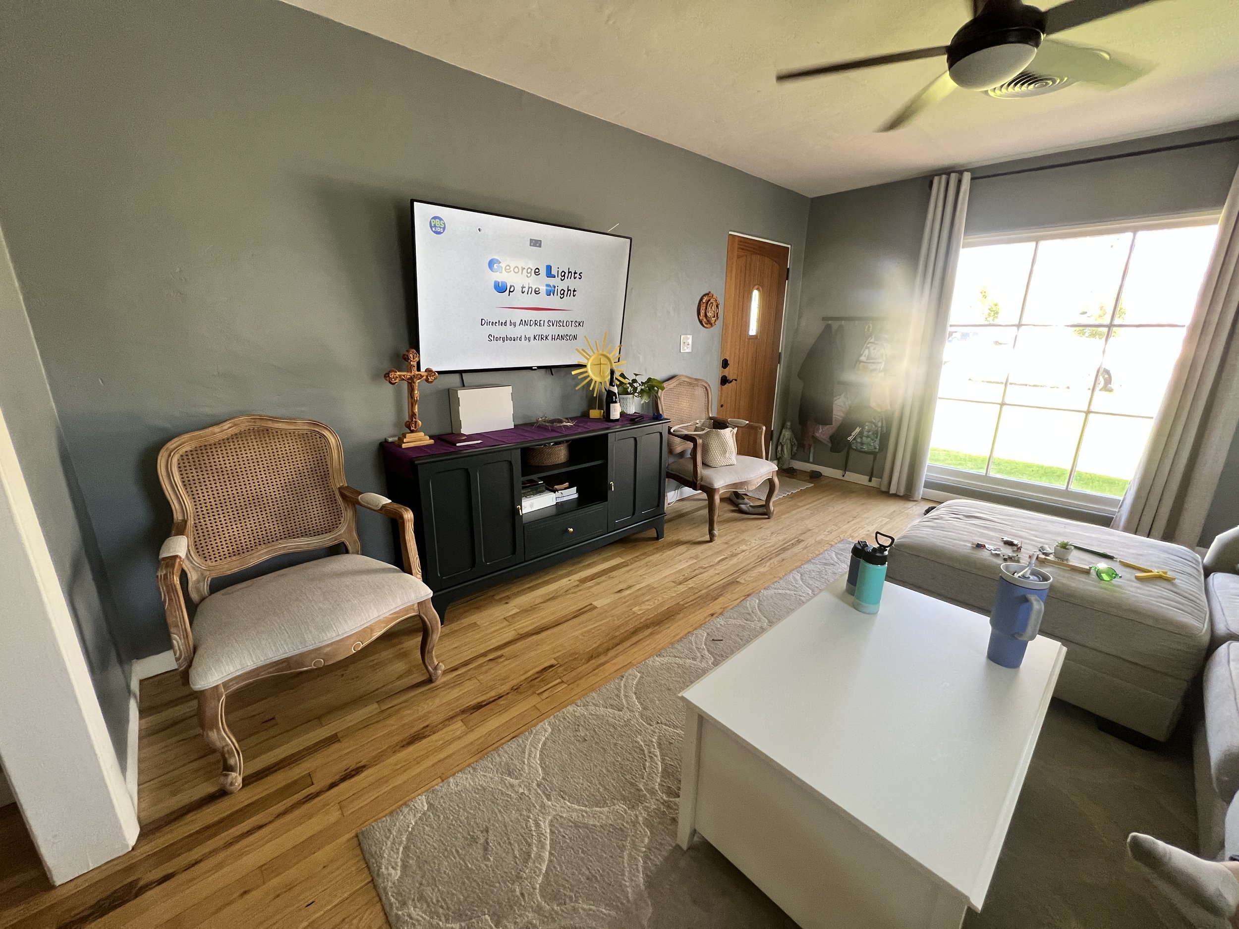 Warm wood tones and layered linen textures in historical Mesa bungalow living room renovation