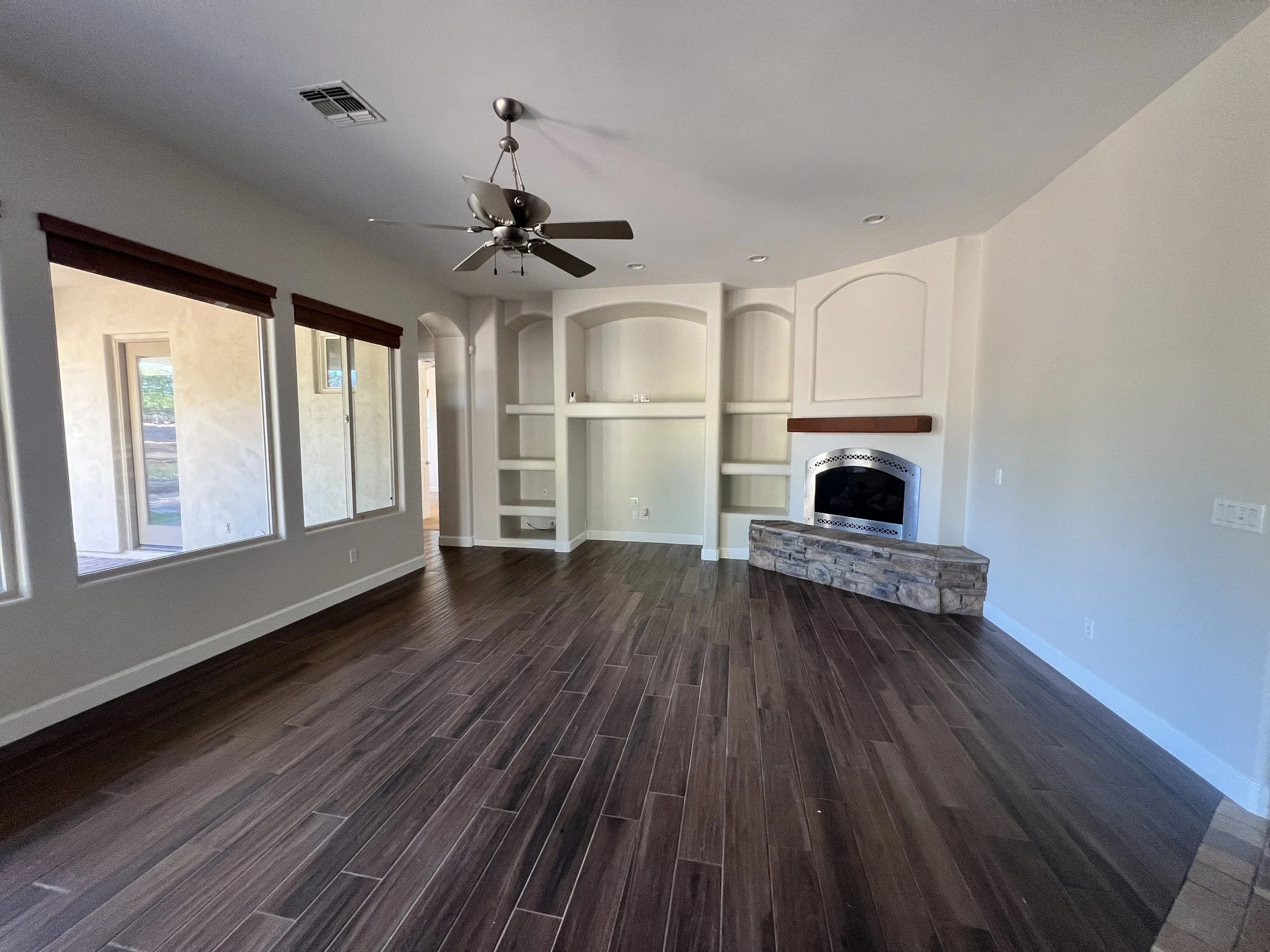 Living room before renovation showing limited layout and outdated finishes