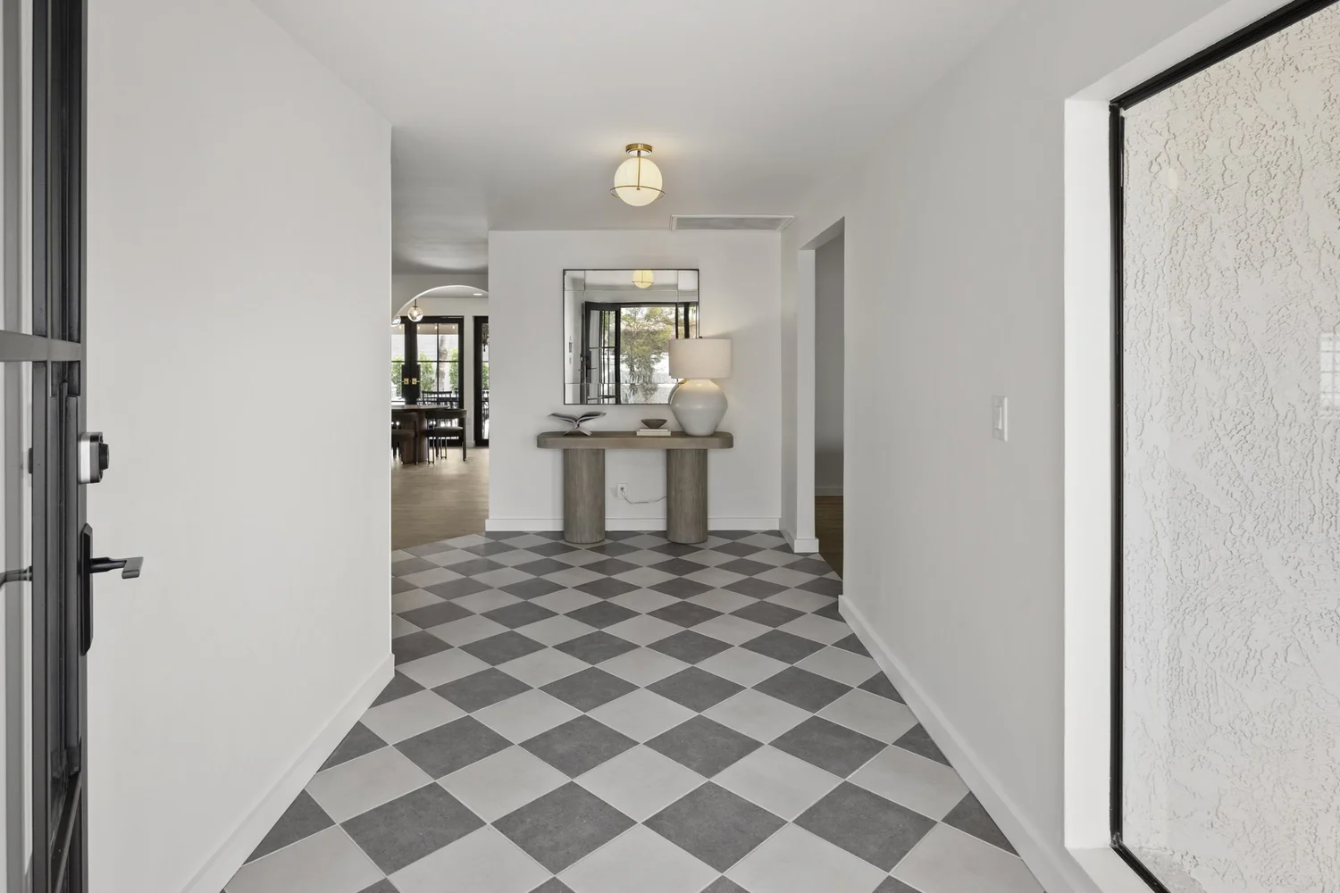 Maison 1975 entry with original 1975 proportions preserved, custom console, layered neutrals