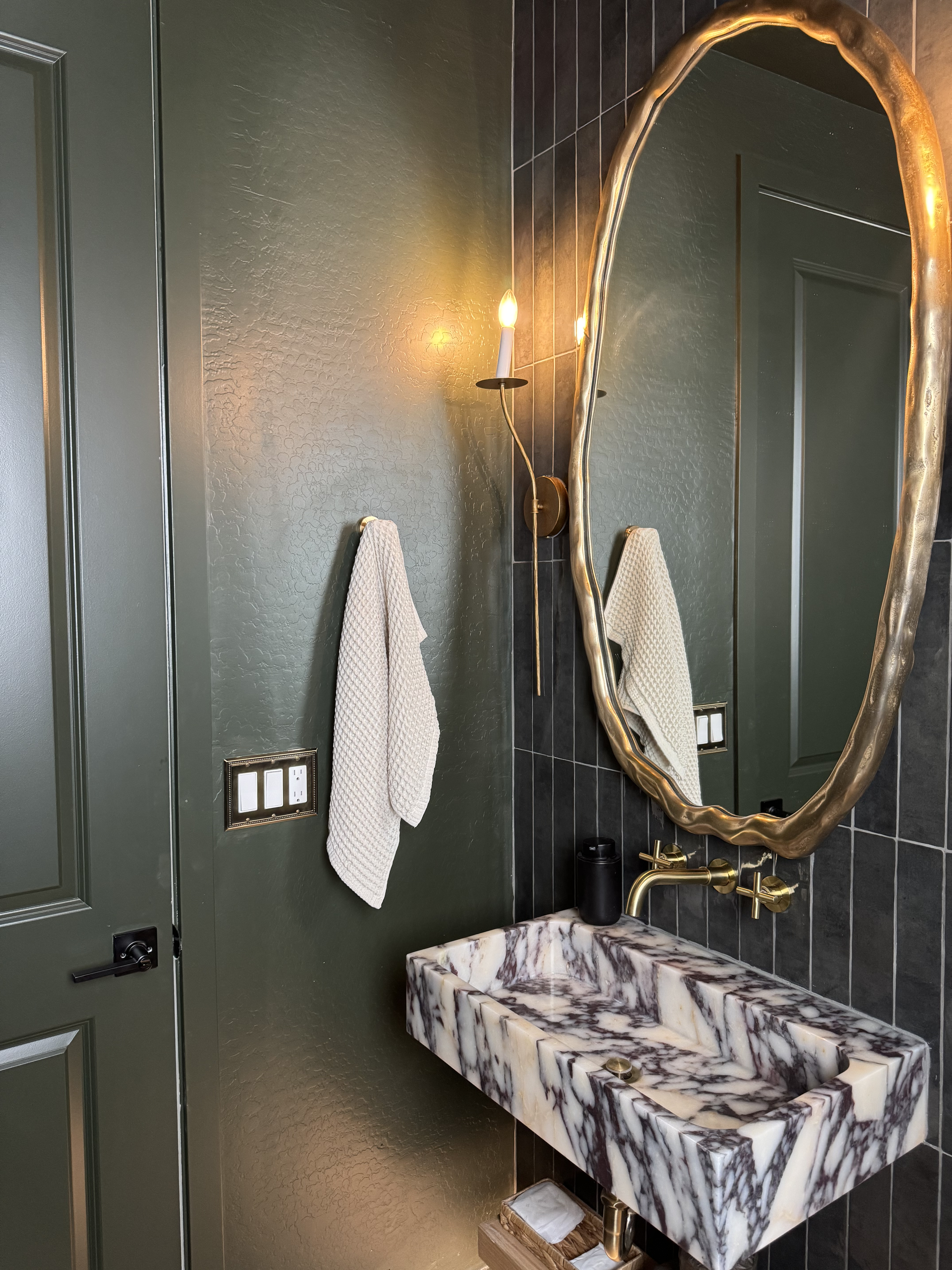 Brass towel rack adding luxury to modern edgy design