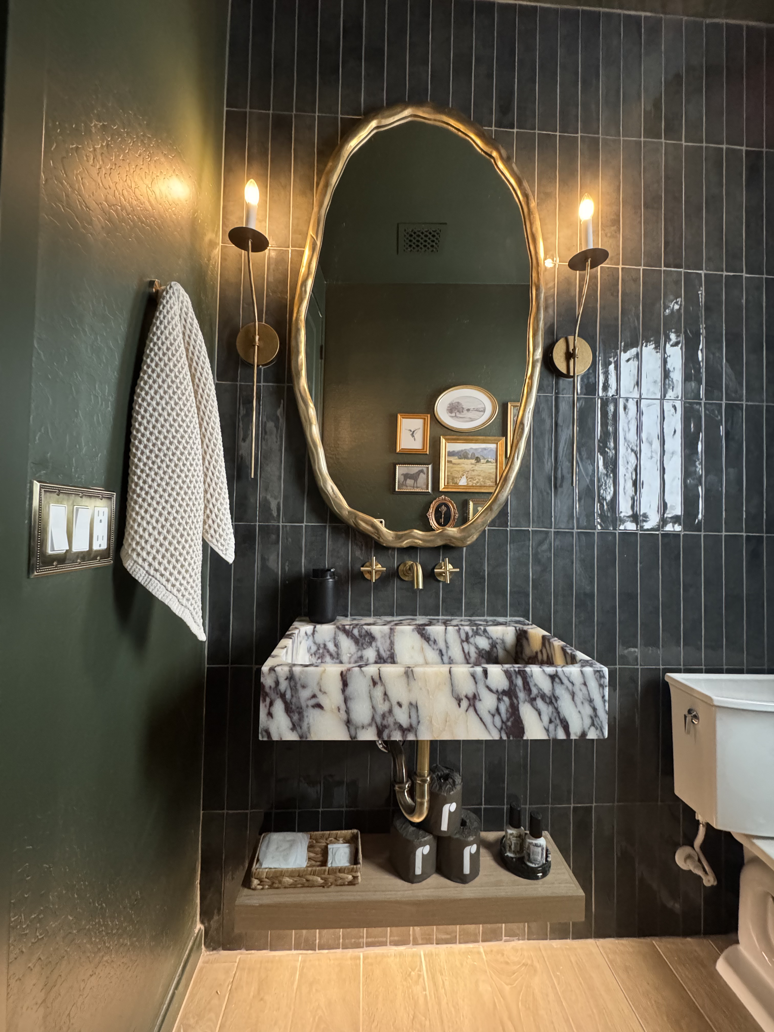 Marble sink with brass faucet in edgy powder room design