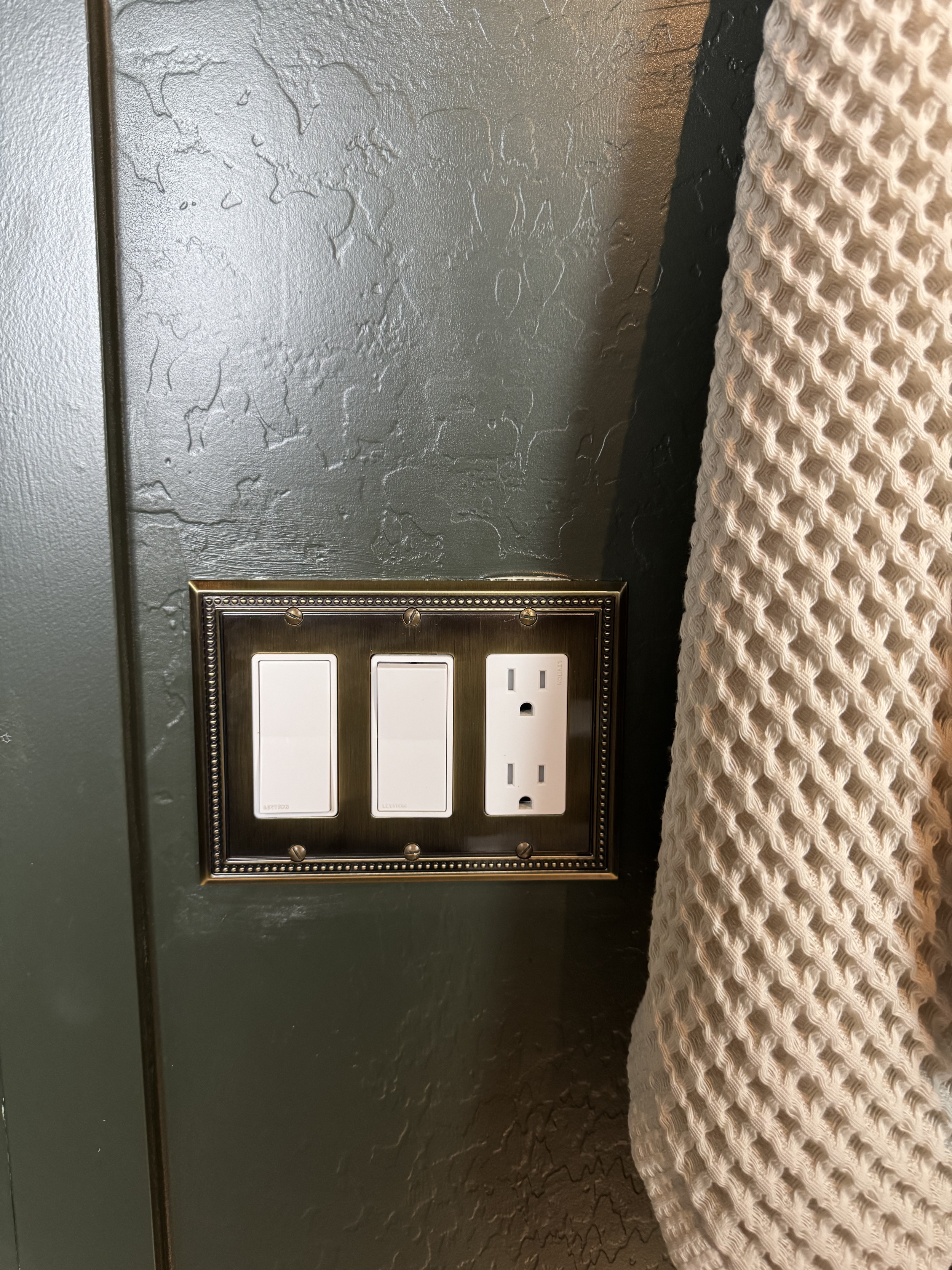 "Textured green wallpaper in contemporary powder room."