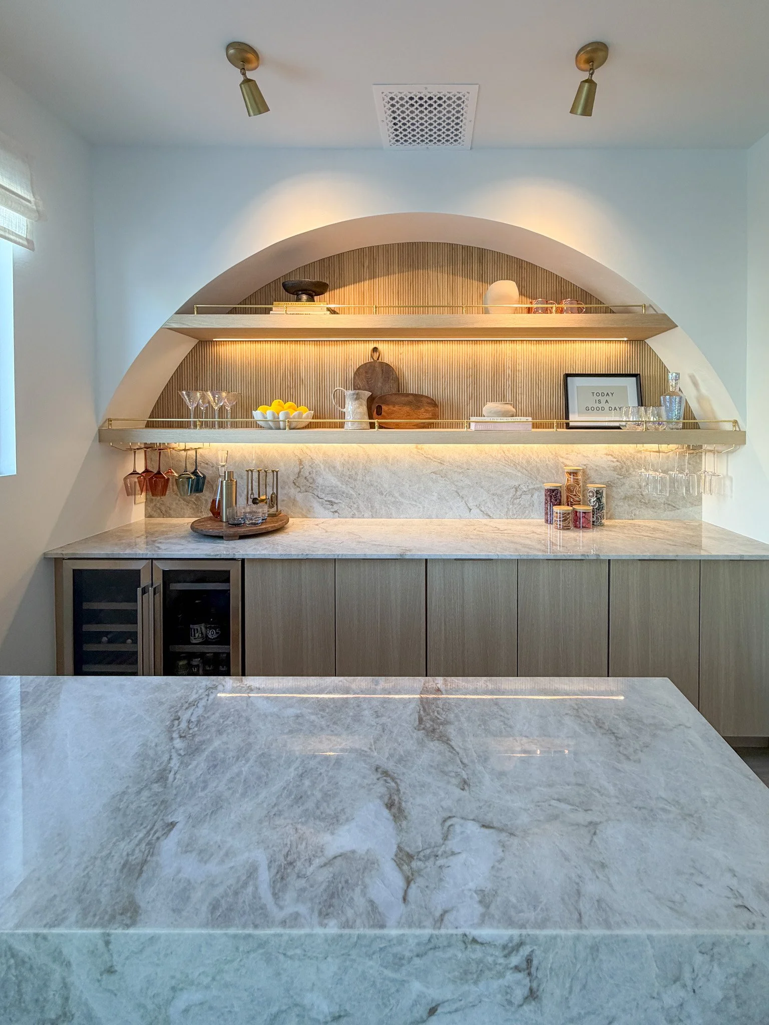 Detailed sketch with dimensions, arched design, brass rails, slim panels, hidden hardware, white oak, marble, and lighting notes.