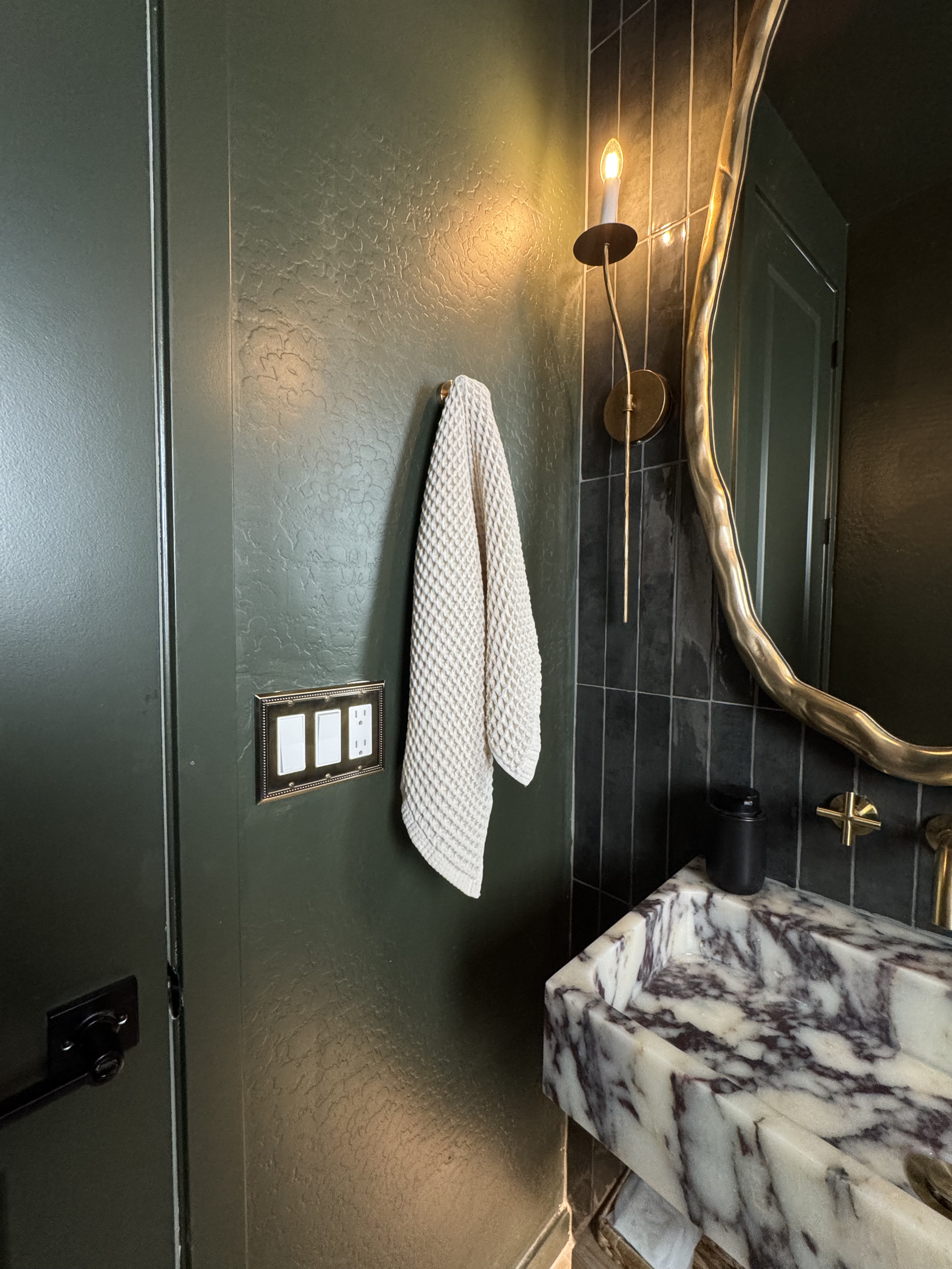 Brass sconce lighting in Modern Edgy Powder Room.