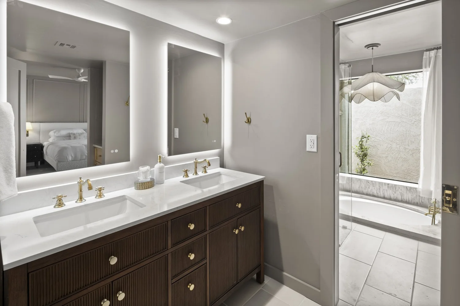 Primary bath with honed marble and custom millwork chosen to age gracefully