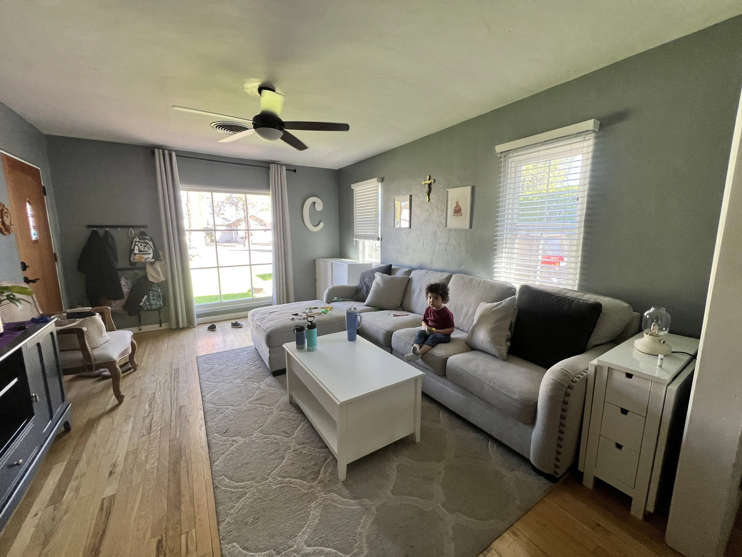 Warm wood tones and layered linen textures in historical Mesa bungalow living room renovation