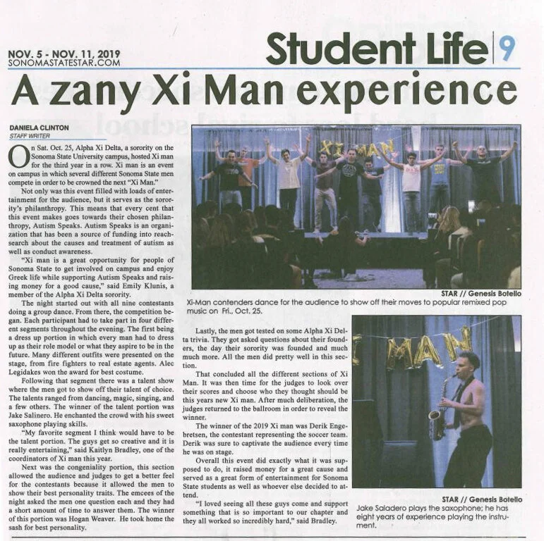 Photograph of a live stage performance by Xi-Man contestants, with performers dancing and playing musical instruments, on a stage with a purple curtain backdrop.