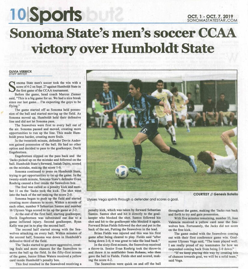 A newspaper sports article with a photo of a soccer player in blue initiating a play during a game, with other players and a referee visible in the background.