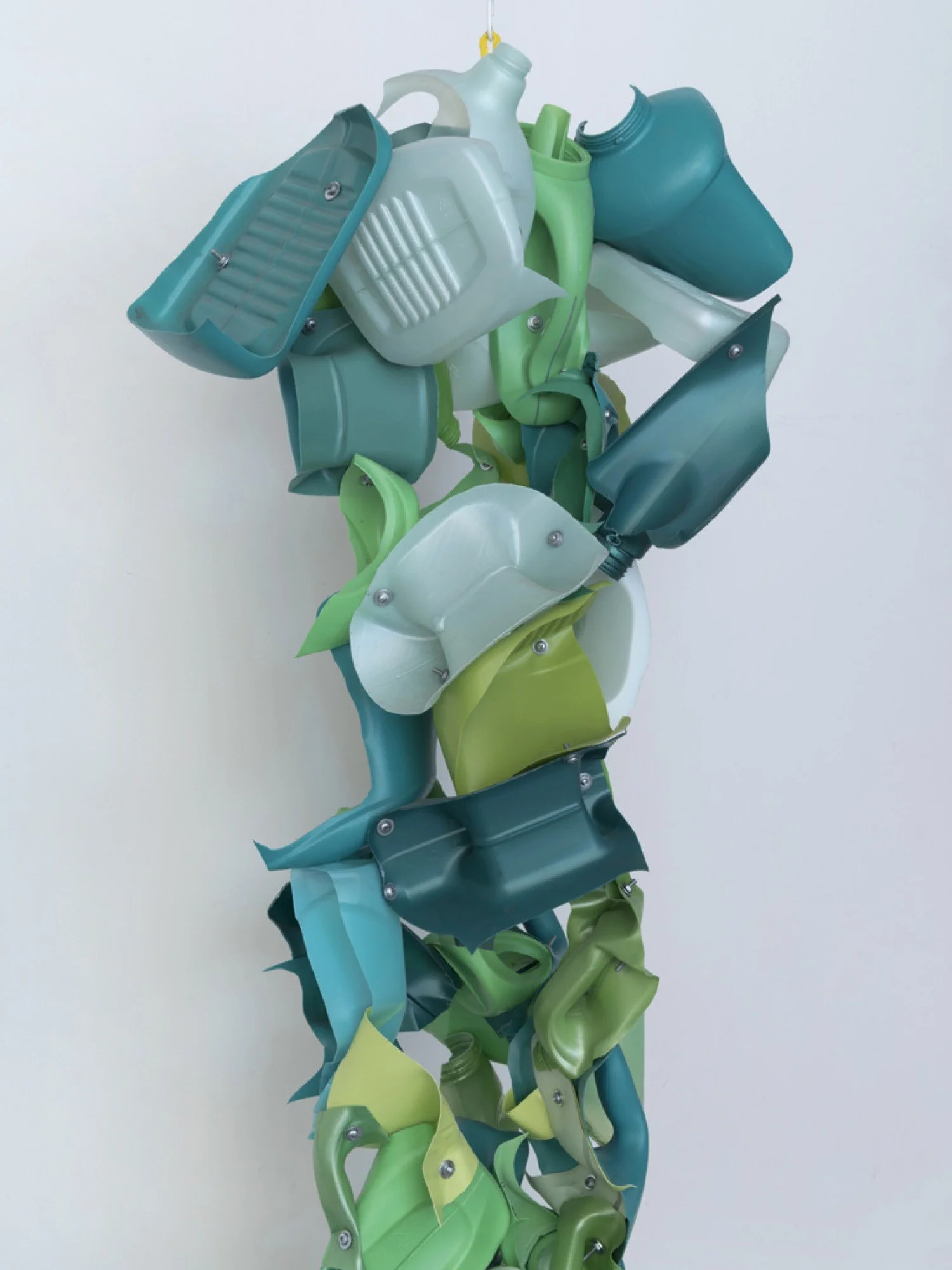 Detail of suspended sculpture made from Gain, Purex, and Cascade detergent bottles, machine screws, hex nuts, and nylon rope