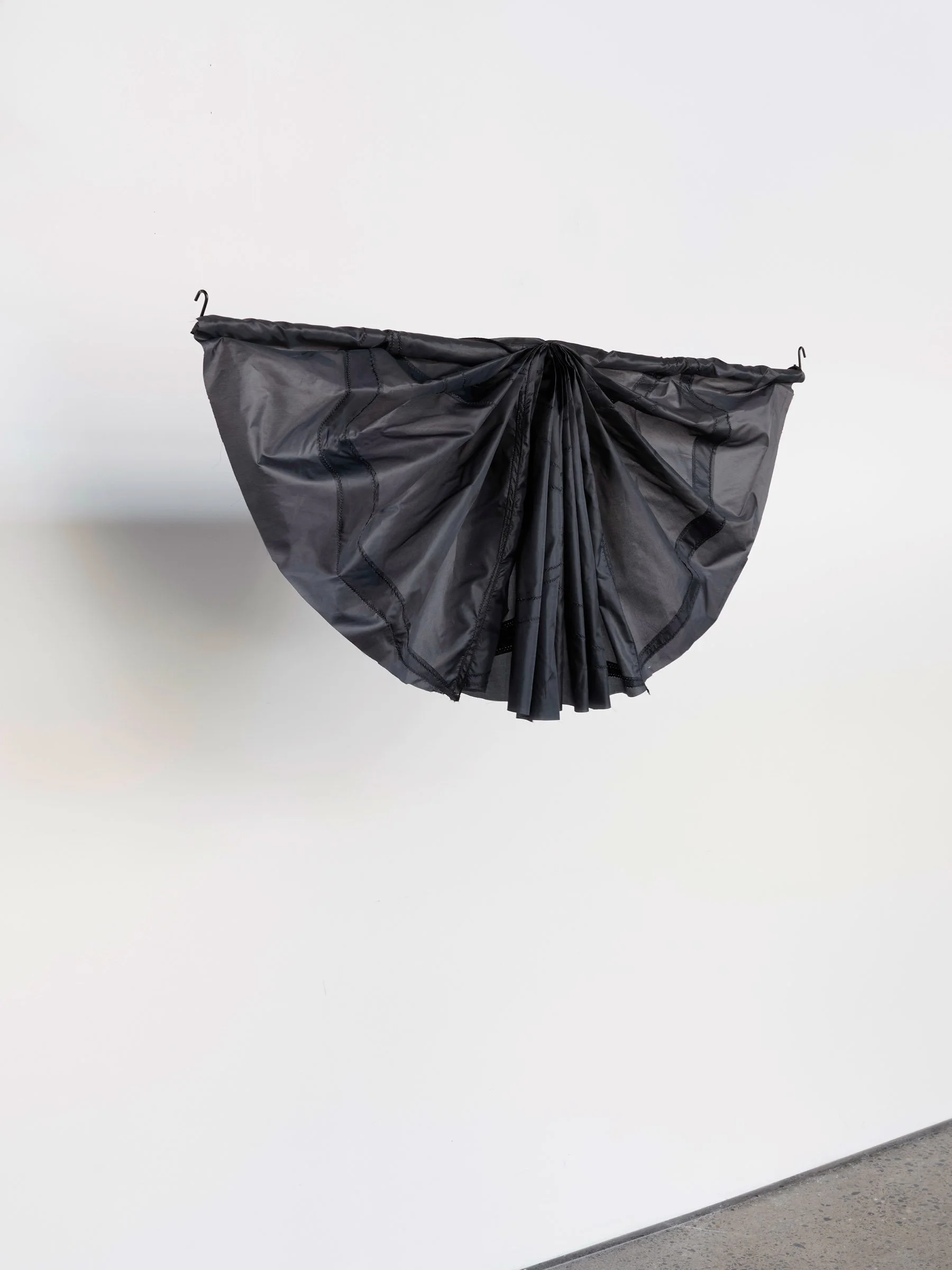 Mourning Bunting study, small, suspended sculpture of black umbrella material gathered into a compact curved form