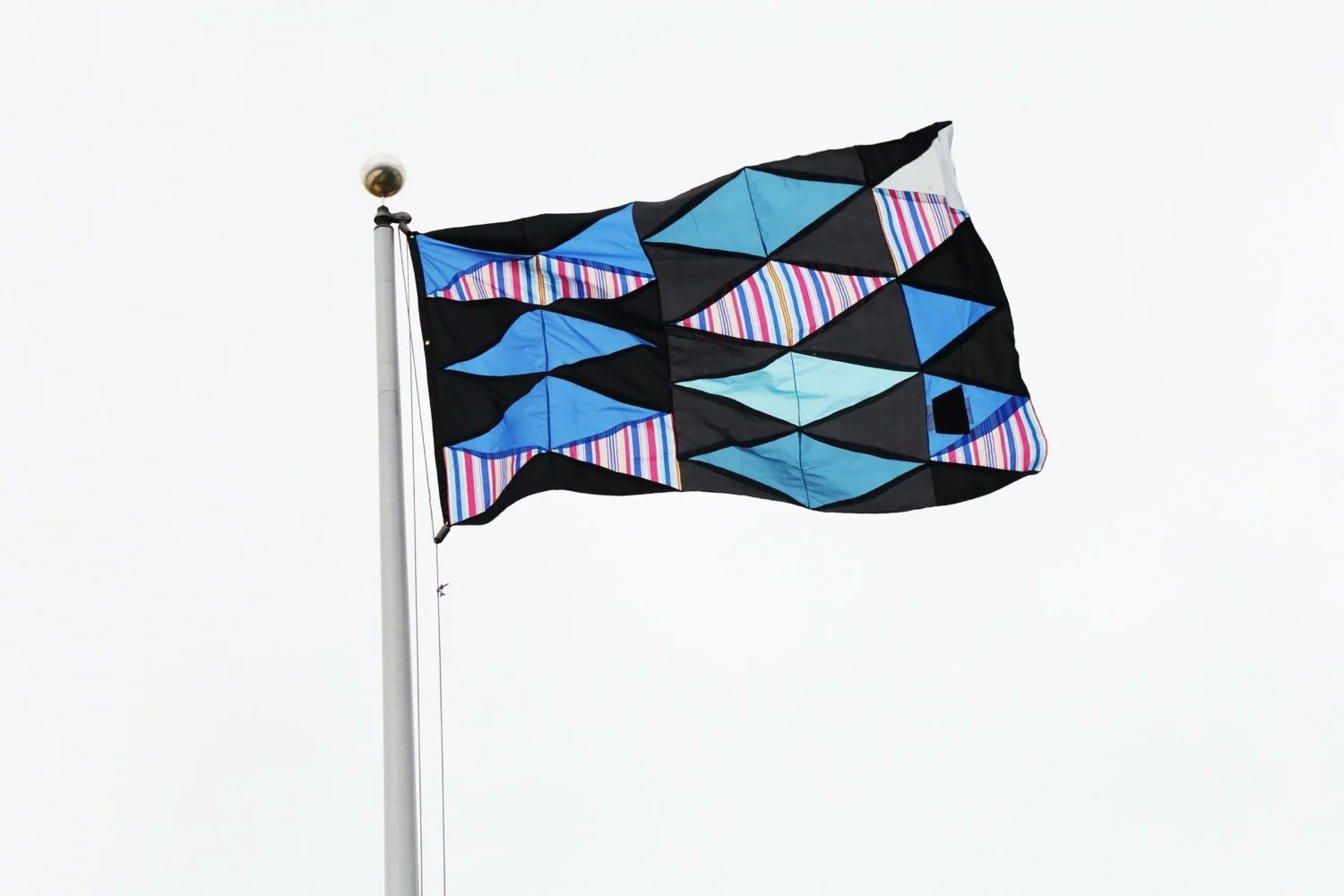Installation view of flag sculpture made of umbrella canopies, nylon thread, nylon webbing, and grommets