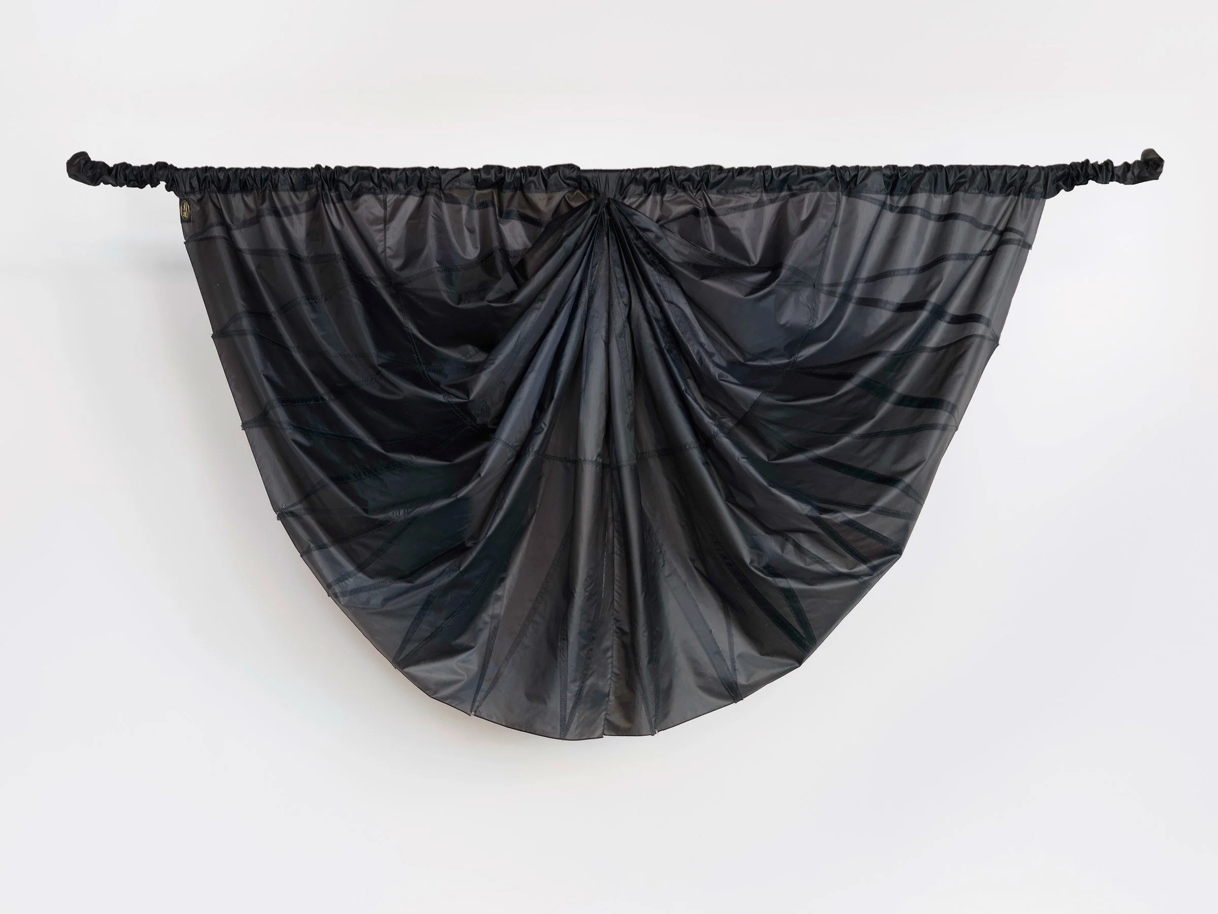 Big Mourning, alternate view of suspended sculpture of draped black umbrella canopy fabric gathered into a wide curved form