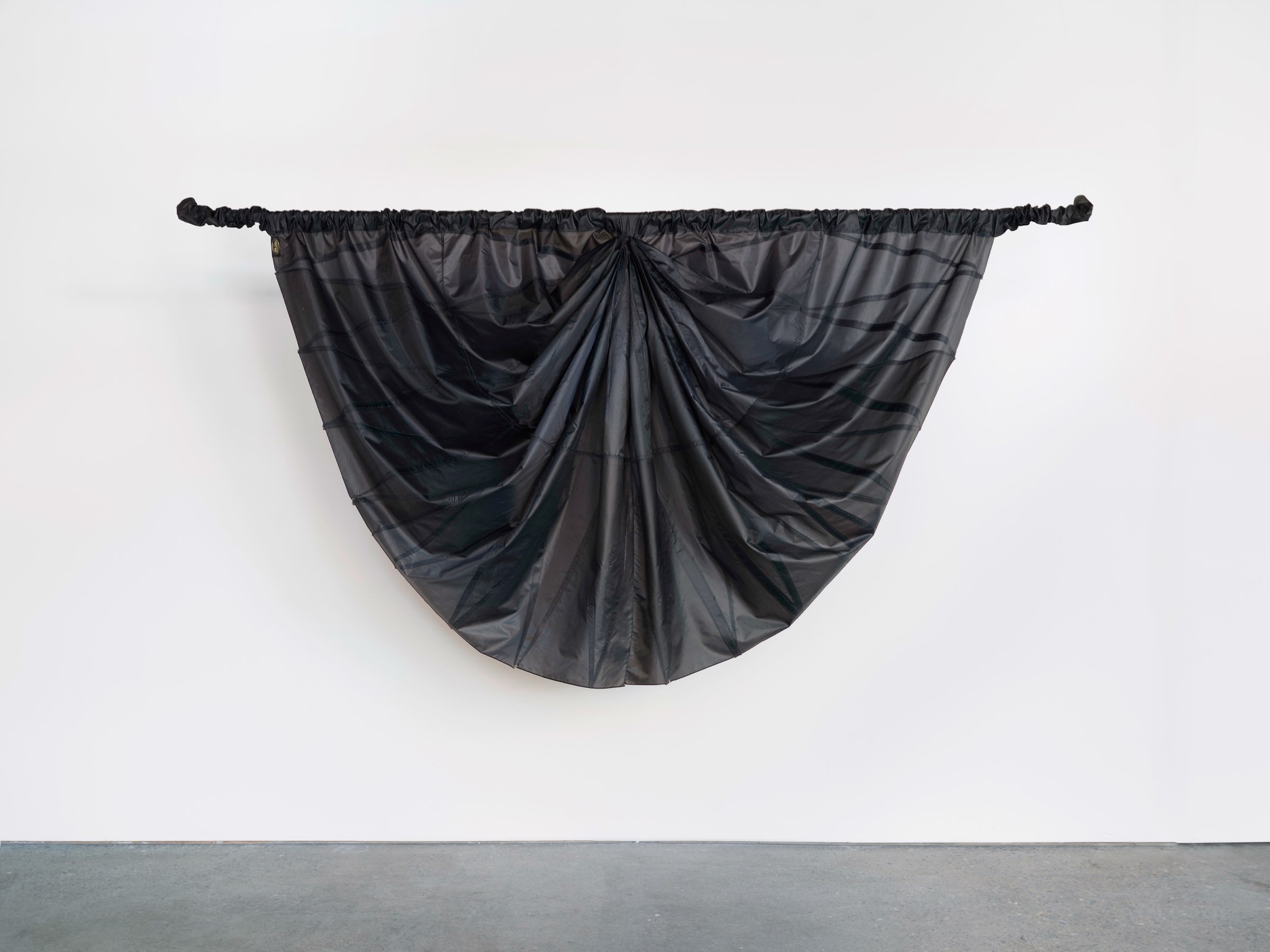 Big Mourning, suspended sculpture of draped black umbrella canopy fabric gathered into a wide curved form