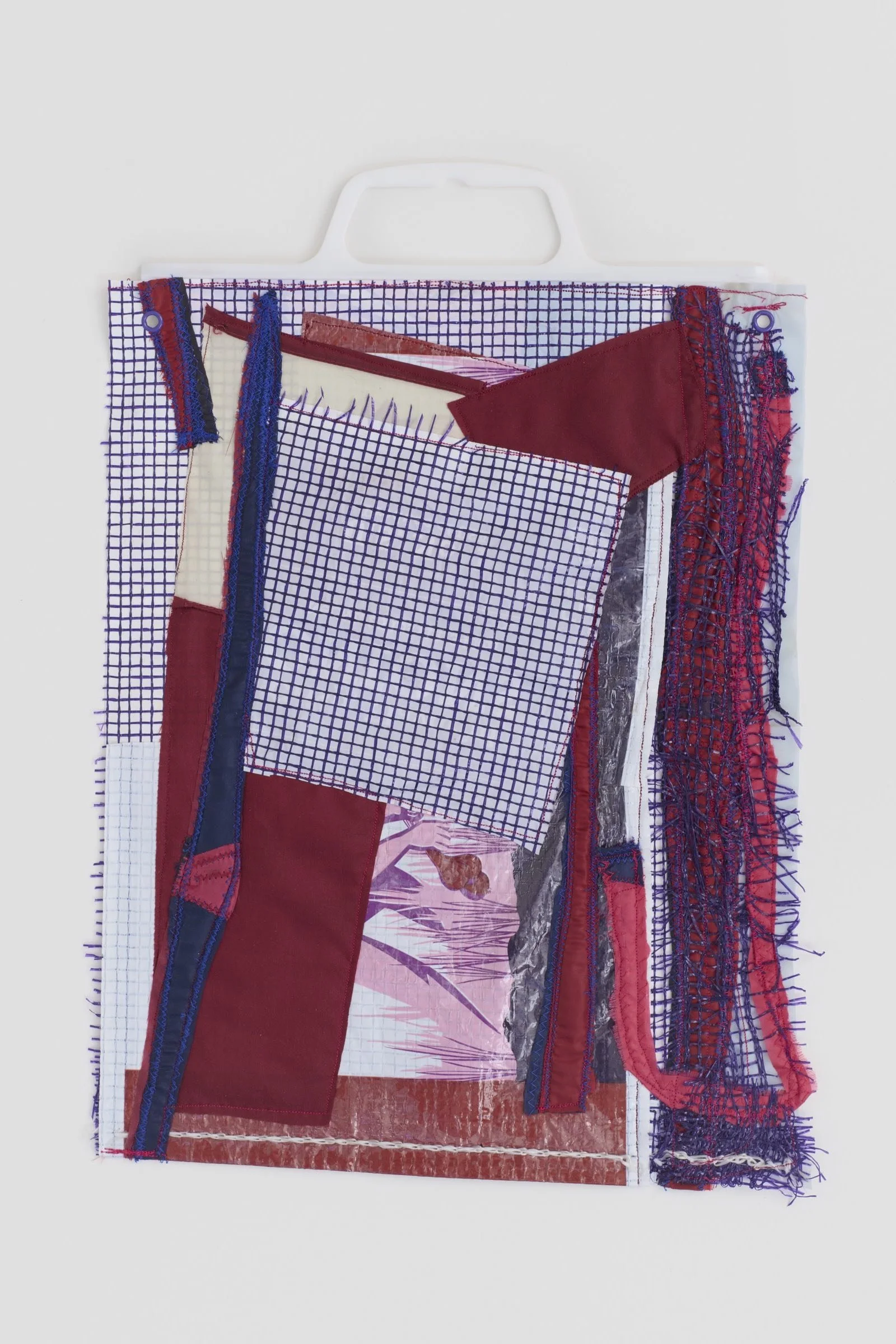 Onion Skin is a wall-based artwork made of overlapping recycled nylon mesh onion bag with plastic bag handle