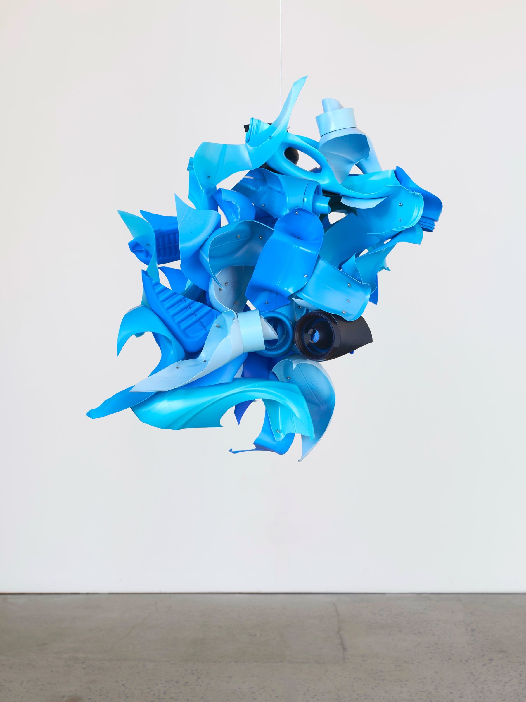 Blue Bonnet, suspended sculpture of bright blue repurposed plastic pieces with curved and ribbon-like elements