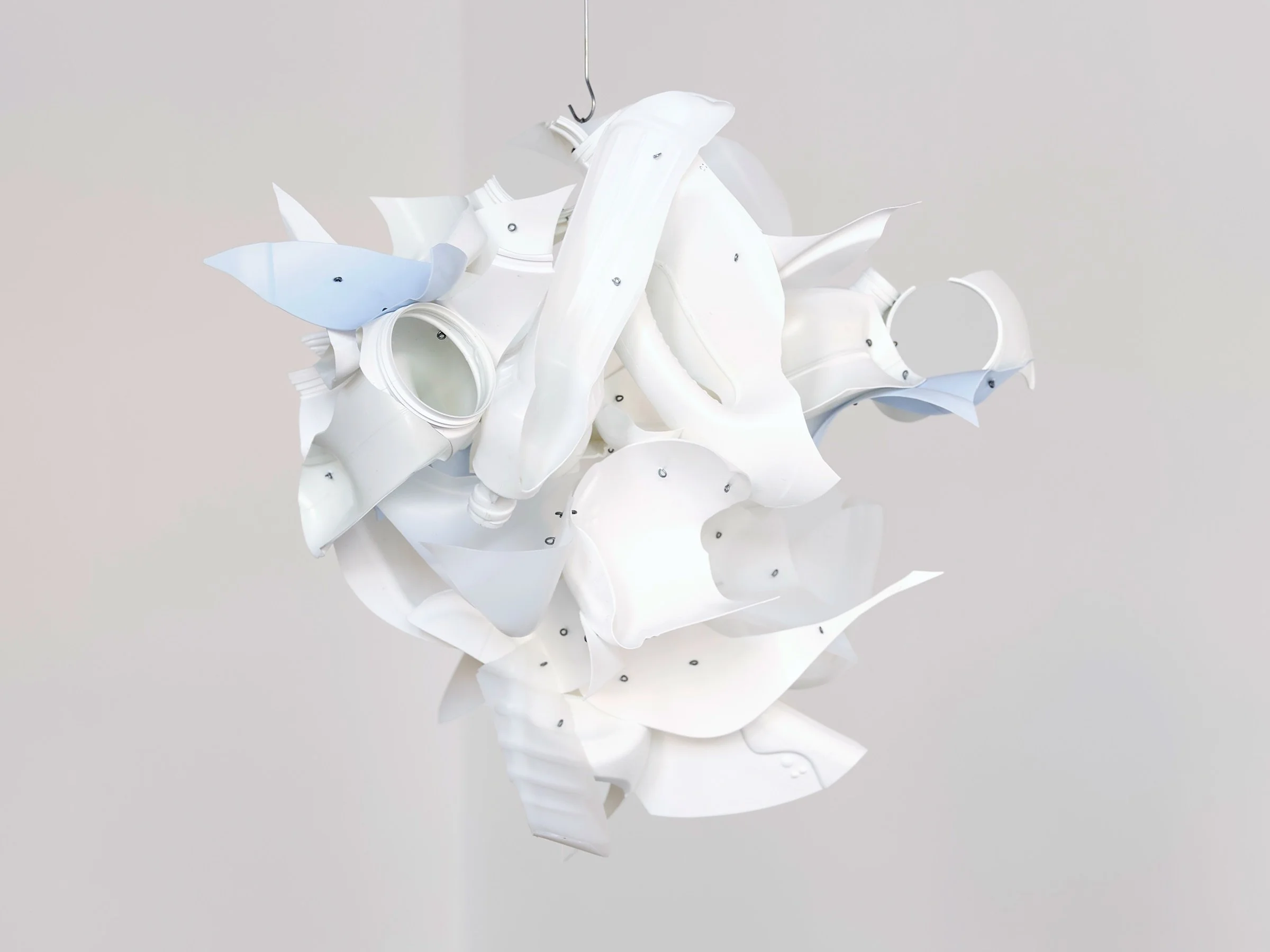 Cloud Car, alternate view of suspended sculpture of white repurposed plastic fragments forming a clustered abstract shape