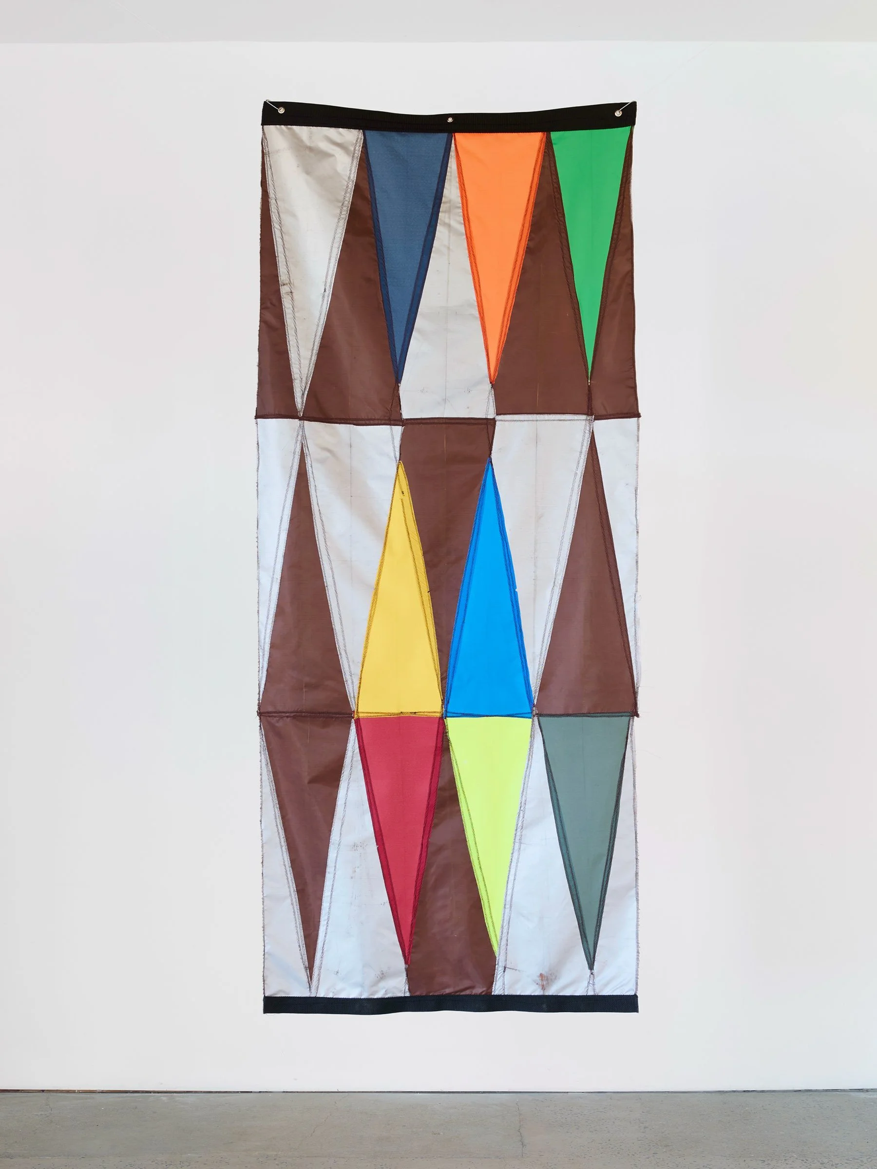 Double Digit Diptych Brown, wall-mounted textile artwork with geometric triangular panels in brown and multicolored fabric