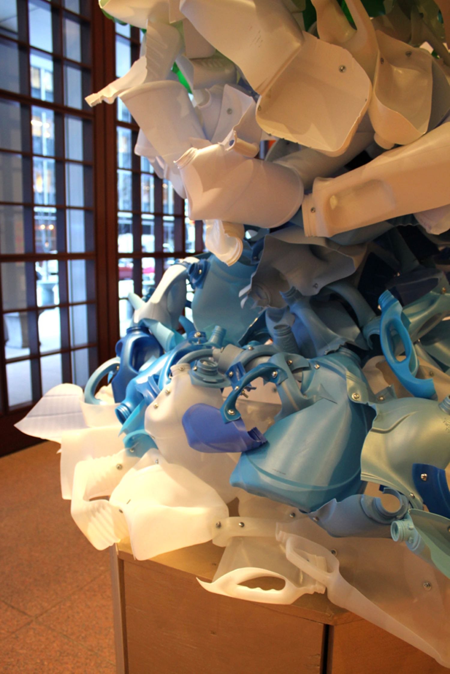 Sculpture made from recycled plastic bottles, machine screws, hex nuts, steel pipe, plywood, acrylic paint