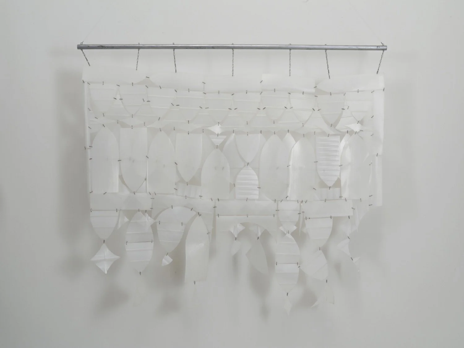 Hanging sculpture made of repurposed plastic milk bottles, recycled plastic cooking oil bottles wire fasteners, wood dowel, acrylic paint, chain